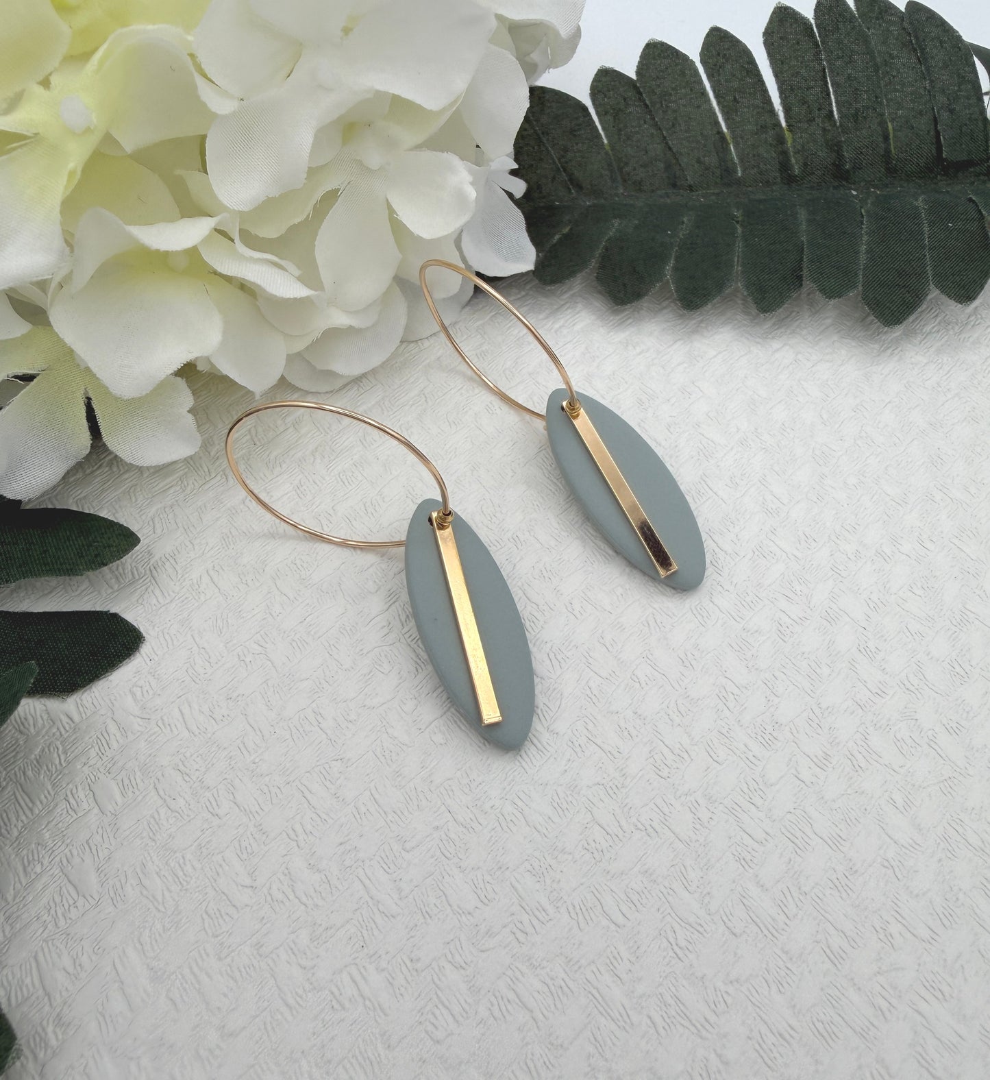 Earrings Made with Blue Polymer Clay Shaped into Ovals with Gold Plated LInes on Hoops PCE-1043