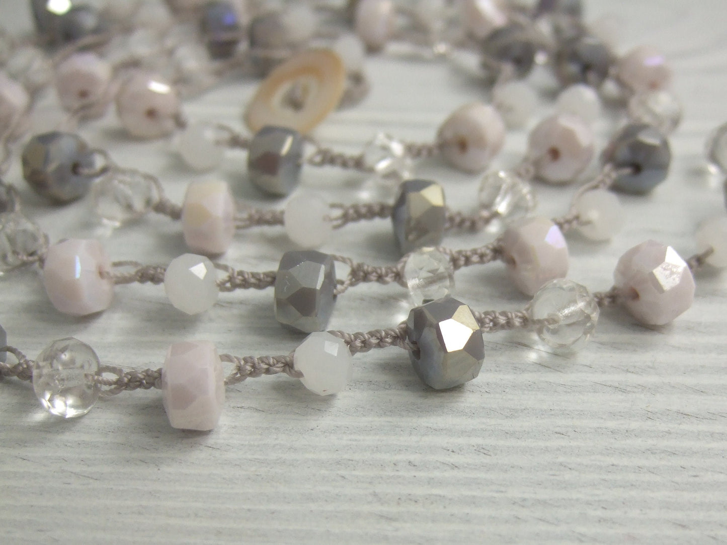 A Long, Hand Crocheted Necklace with a Gray Cord, White, Clear, Gray and Pink Crystal Beads SN-577