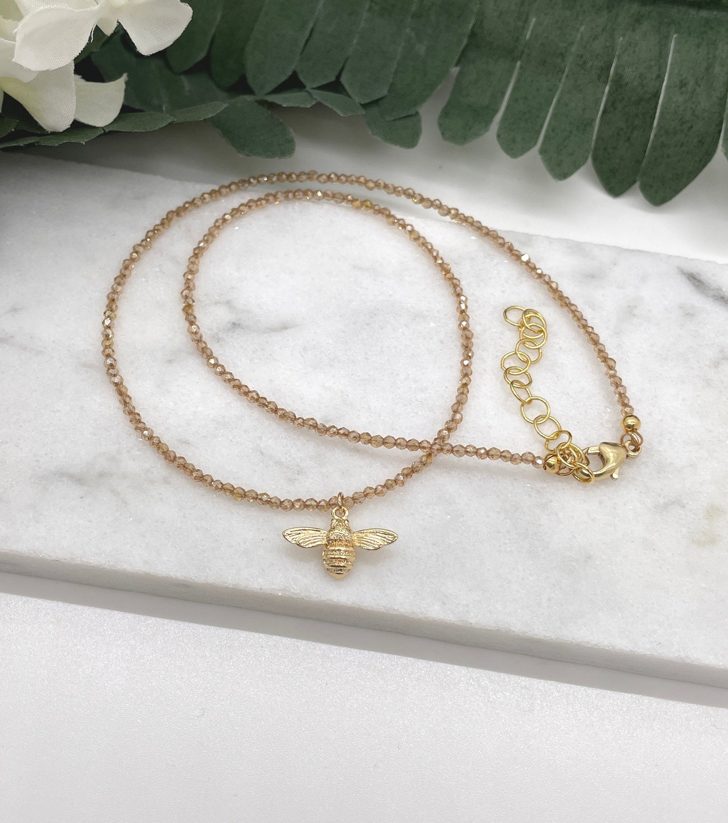 Necklace with Tiny, Honey Colored Crystal Beads and a Gold Plated Bee Charm GCDN-157