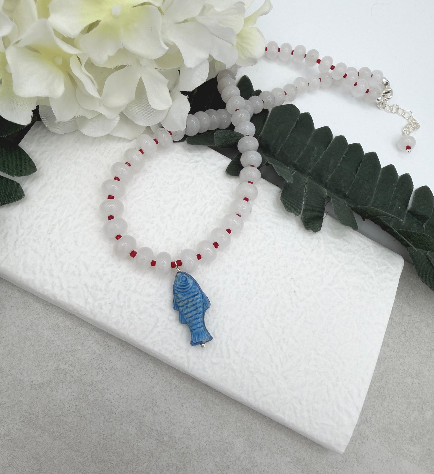 Necklace with White Jade Beads and Red Spacers with a Blue, Czech Glass Fish CDN-959