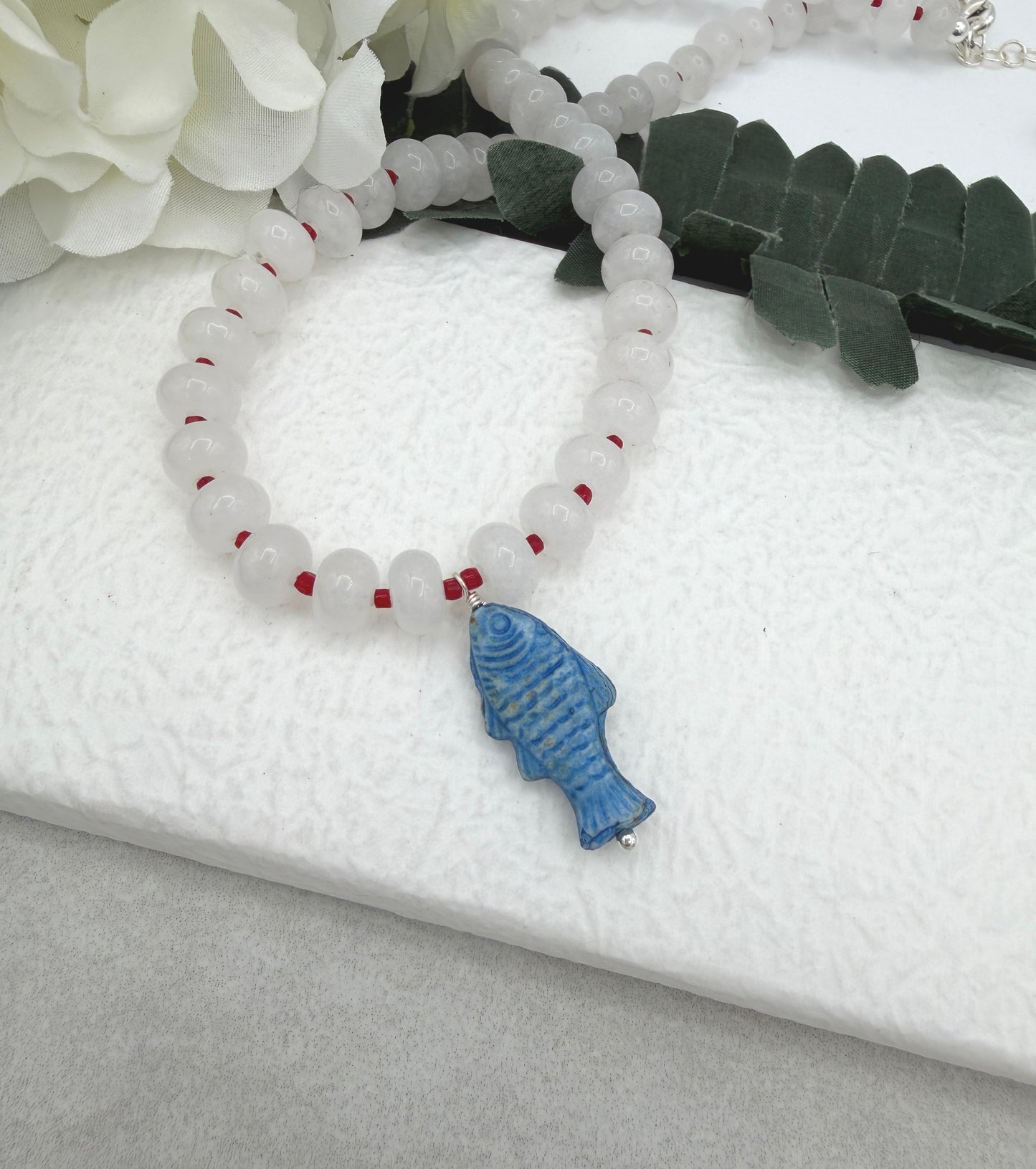 Necklace with White Jade Beads and Red Spacers with a Blue, Czech Glass Fish CDN-959