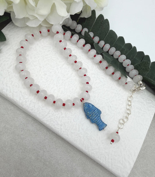 Necklace with White Jade Beads and Red Spacers with a Blue, Czech Glass Fish CDN-959