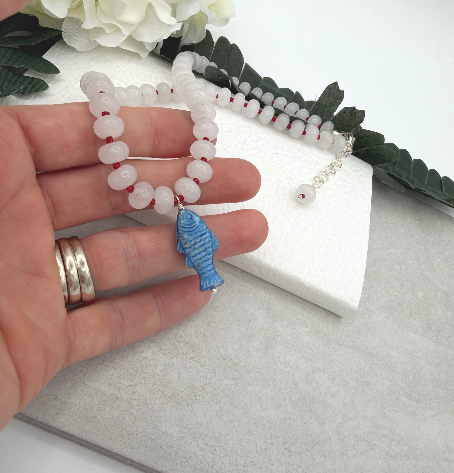 Necklace with White Jade Beads and Red Spacers with a Blue, Czech Glass Fish CDN-959