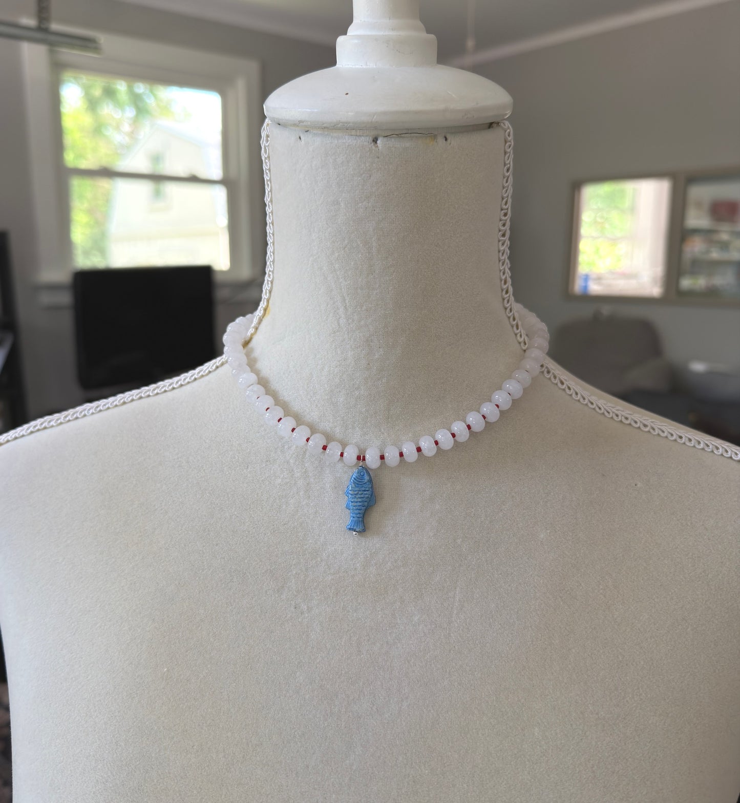 Necklace with White Jade Beads and Red Spacers with a Blue, Czech Glass Fish CDN-959