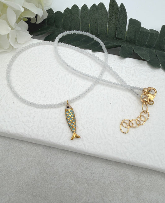 Necklace with Tiny, White Cryatls Beads and a Gold Plated, Enamled Fish Charm GCDN-210