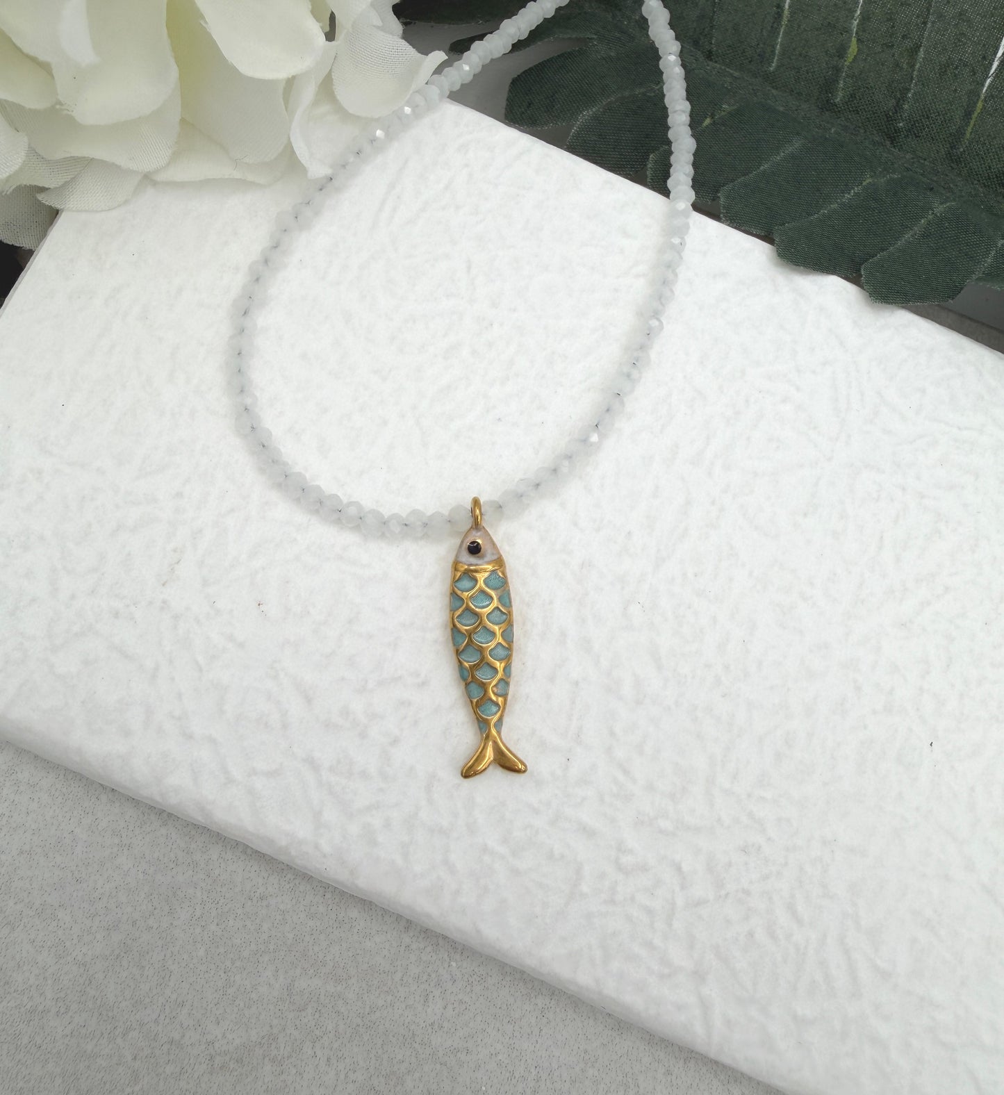 Necklace with Tiny, White Cryatls Beads and a Gold Plated, Enamled Fish Charm GCDN-210