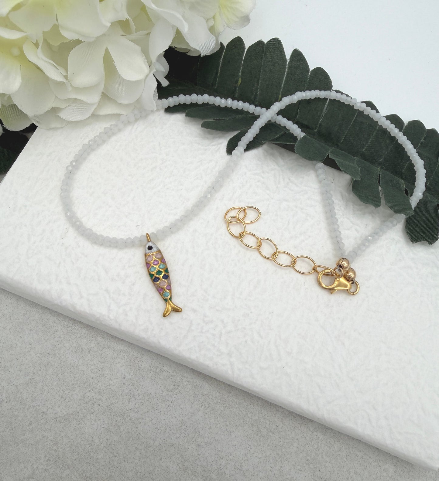 Necklace with Tiny, White Crystal Beads and a Gold Plated, Rainbow Enamled Fish Charm GCDN-212