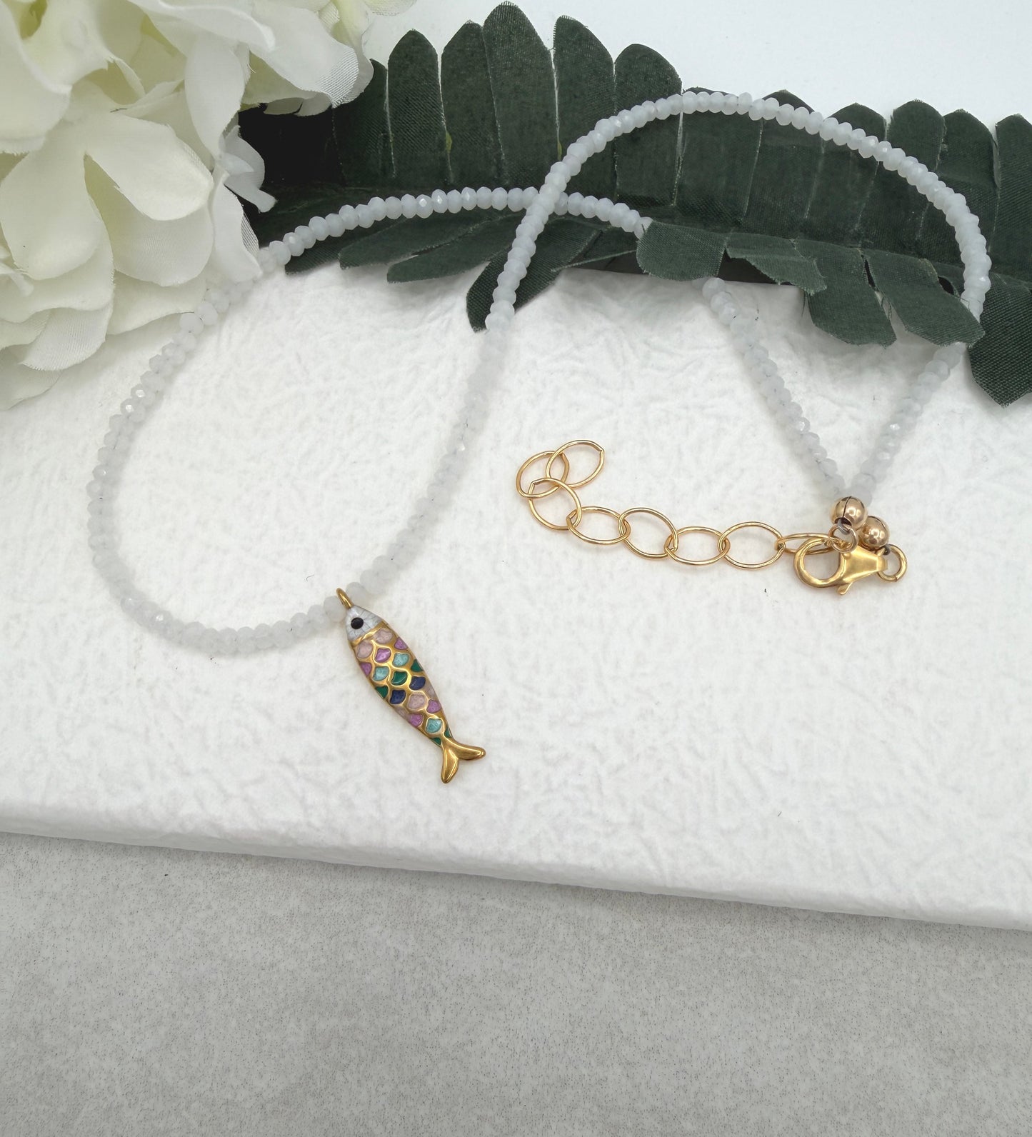 Necklace with Tiny, White Crystal Beads and a Gold Plated, Rainbow Enamled Fish Charm GCDN-212