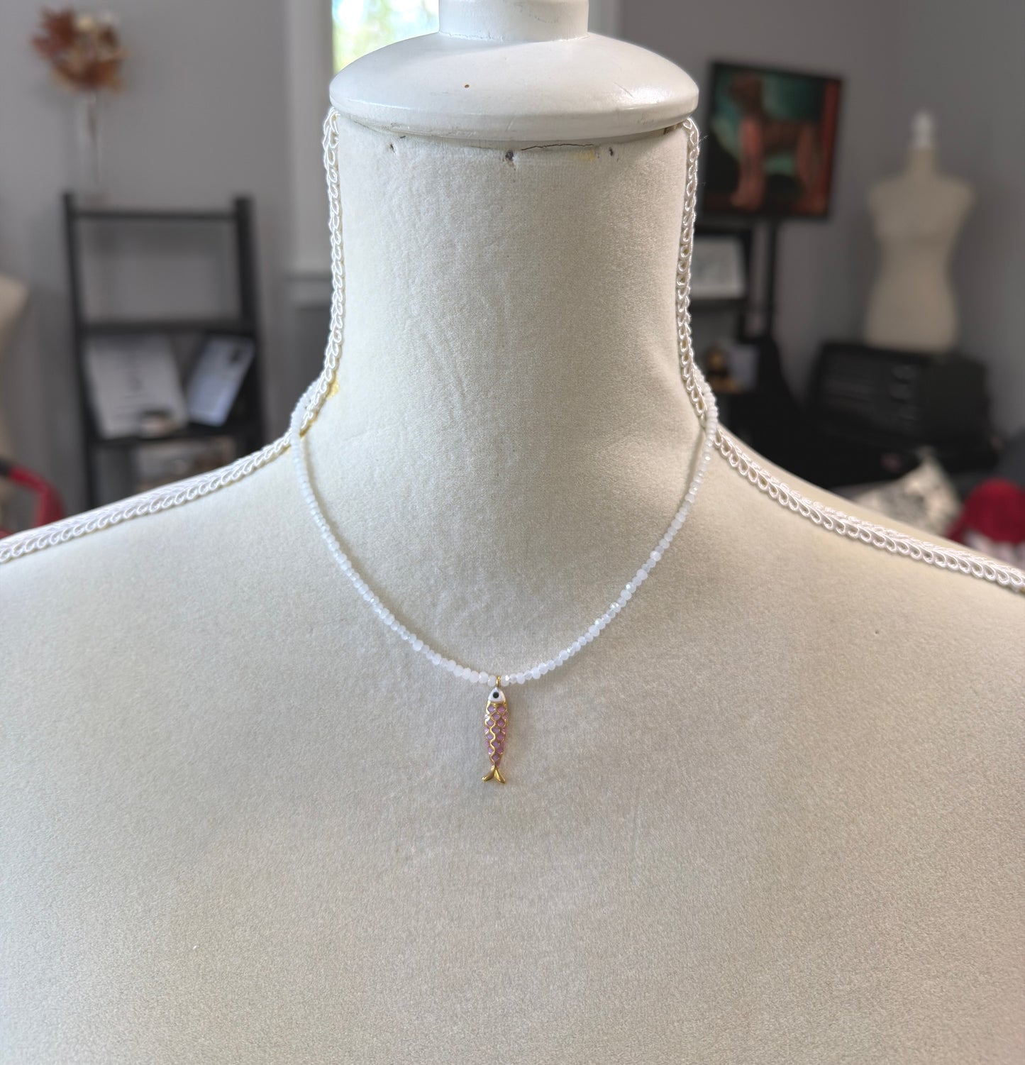 Necklace with Tiny, White Cryatls Beads and a Gold Plated, Pink Enamled Fish Charm GCDN-213