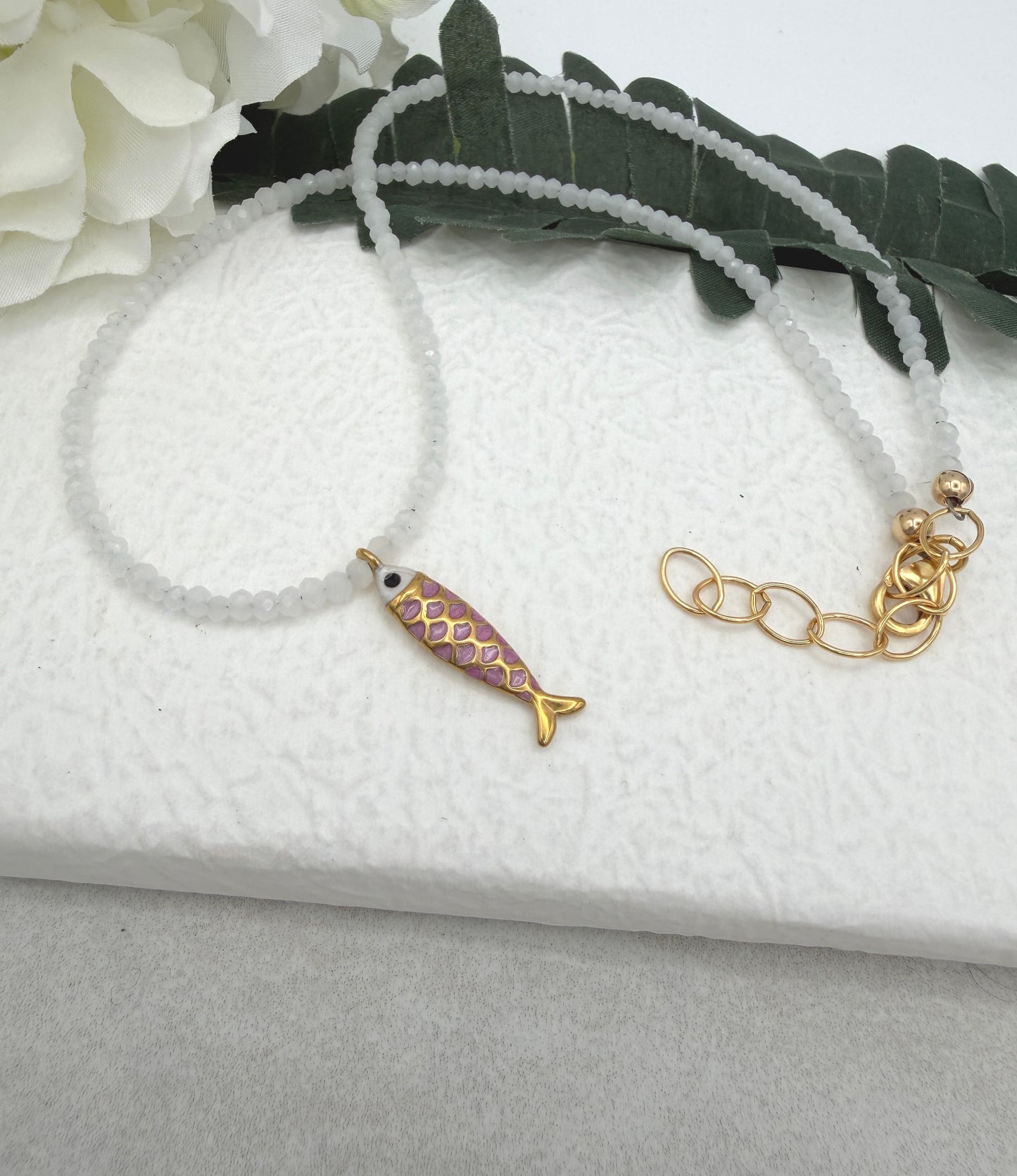 Necklace with Tiny, White Cryatls Beads and a Gold Plated, Pink Enamled Fish Charm GCDN-213