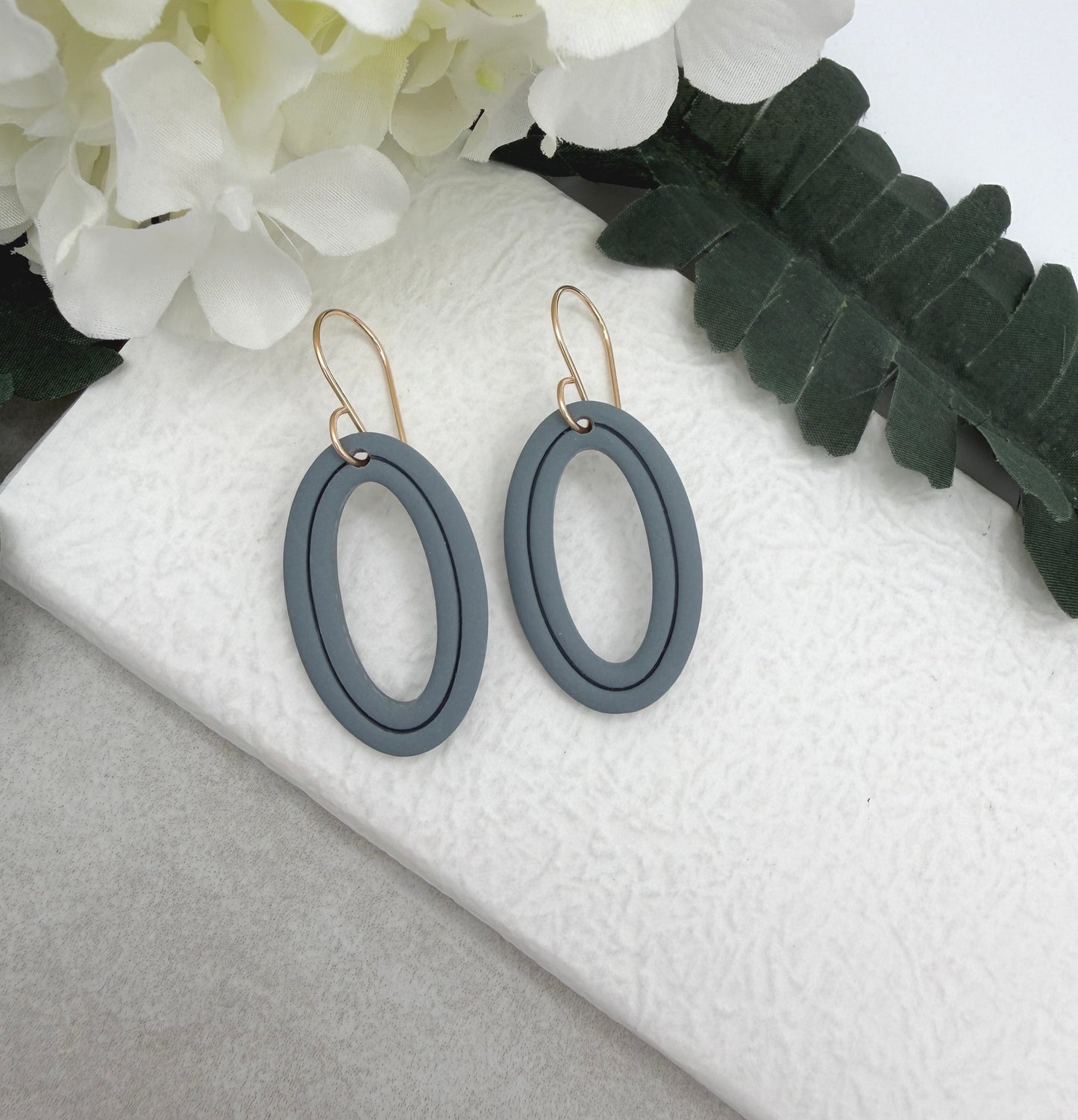 Earrings Made with Blue Polymer Clay Shaped into Lined, Oval Frames PCE-1021