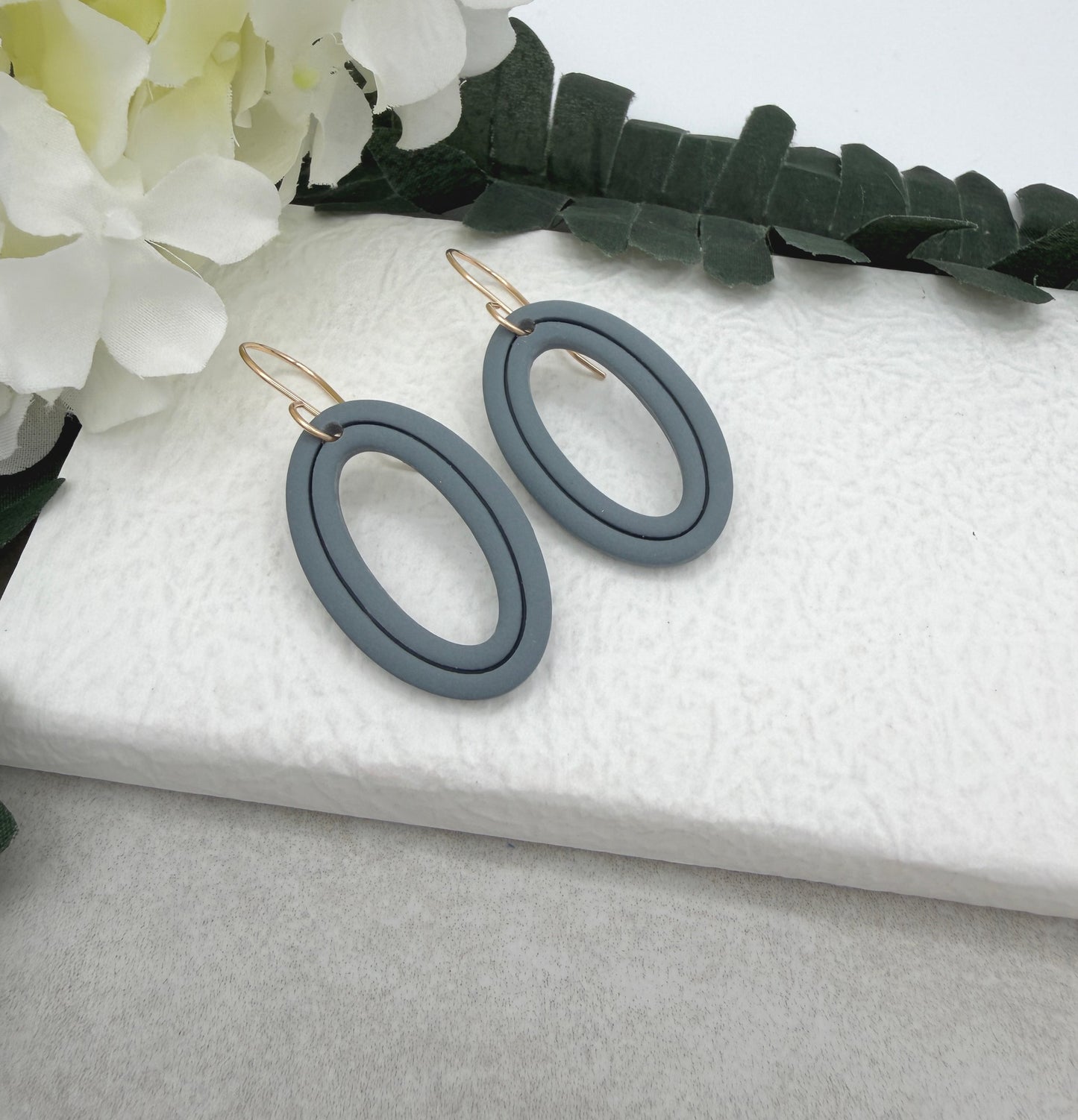 Earrings Made with Blue Polymer Clay Shaped into Lined, Oval Frames PCE-1021