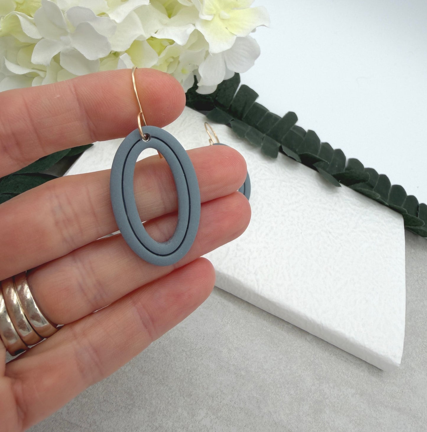 Earrings Made with Blue Polymer Clay Shaped into Lined, Oval Frames PCE-1021
