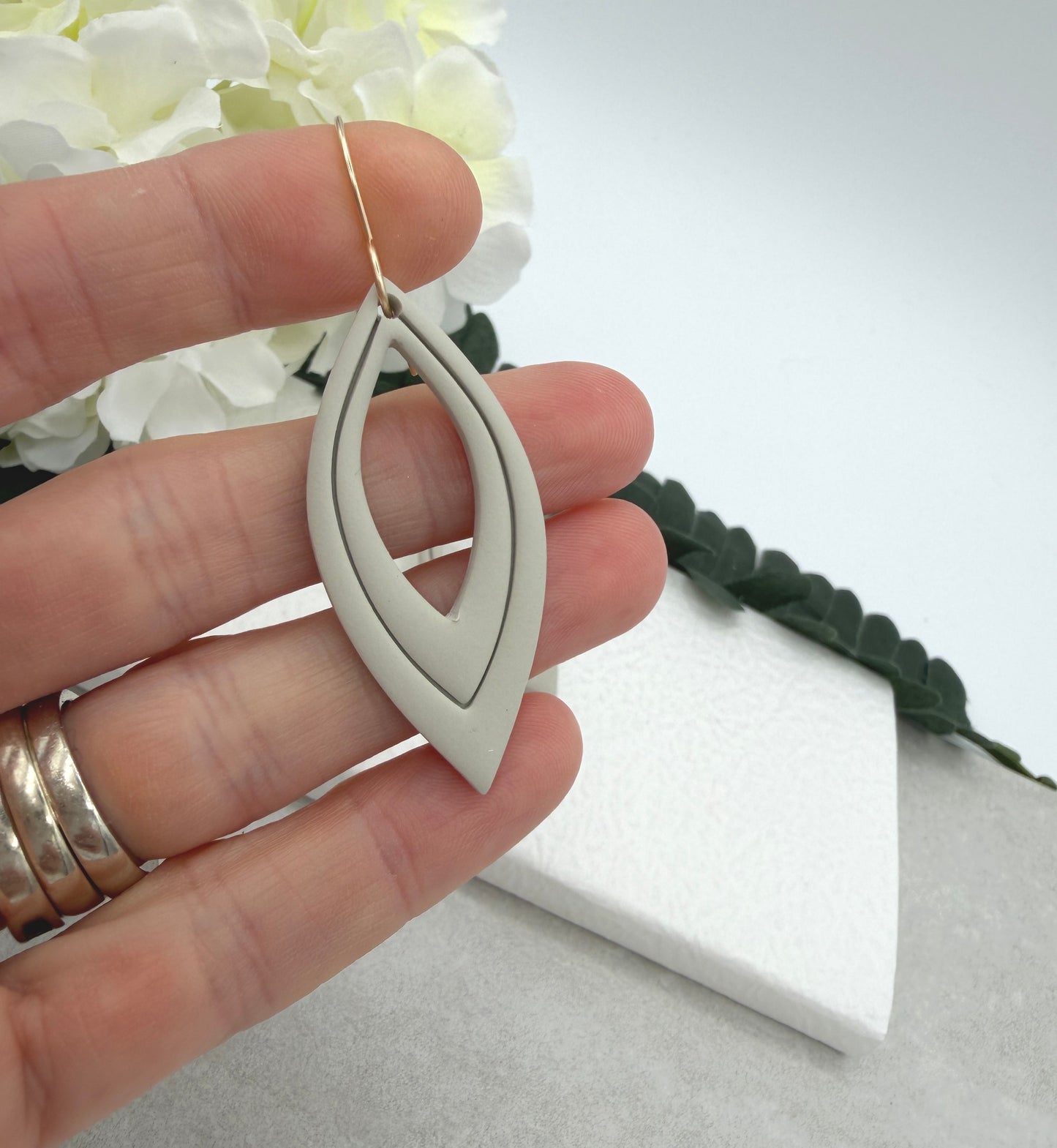 Earrings Made with Beige Polymer Clay Shaped into Lined, Teardrop Frames PCE-1022