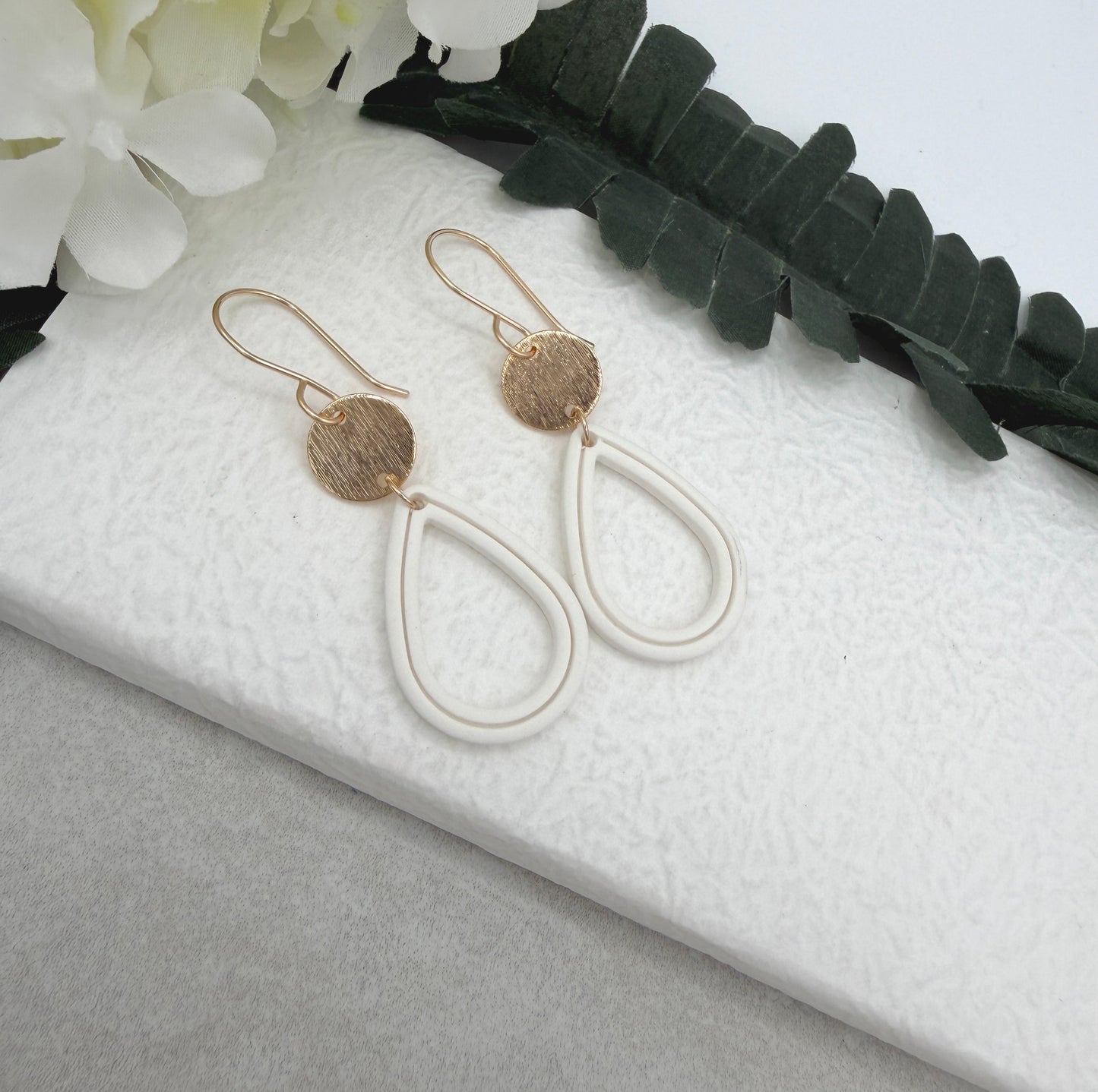 Earrings Made with Gold Plated Circles and White Polymer Clay Shaped into Lined, Teardrop Frames PCE-1023