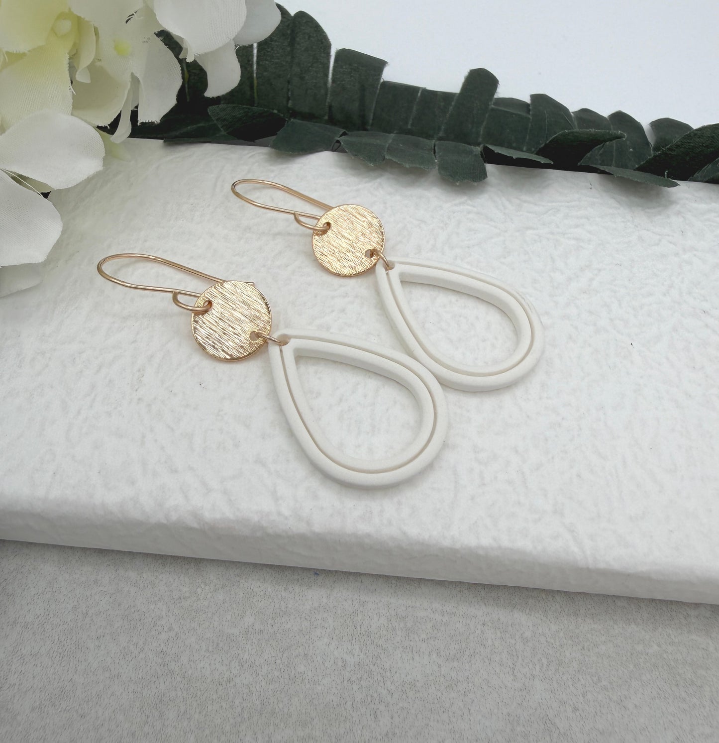 Earrings Made with Gold Plated Circles and White Polymer Clay Shaped into Lined, Teardrop Frames PCE-1023