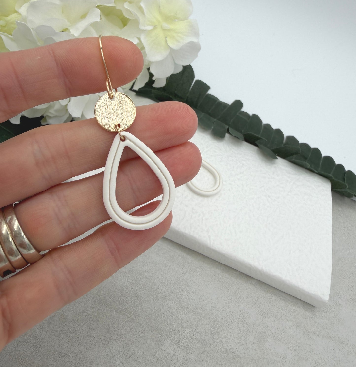 Earrings Made with Gold Plated Circles and White Polymer Clay Shaped into Lined, Teardrop Frames PCE-1023