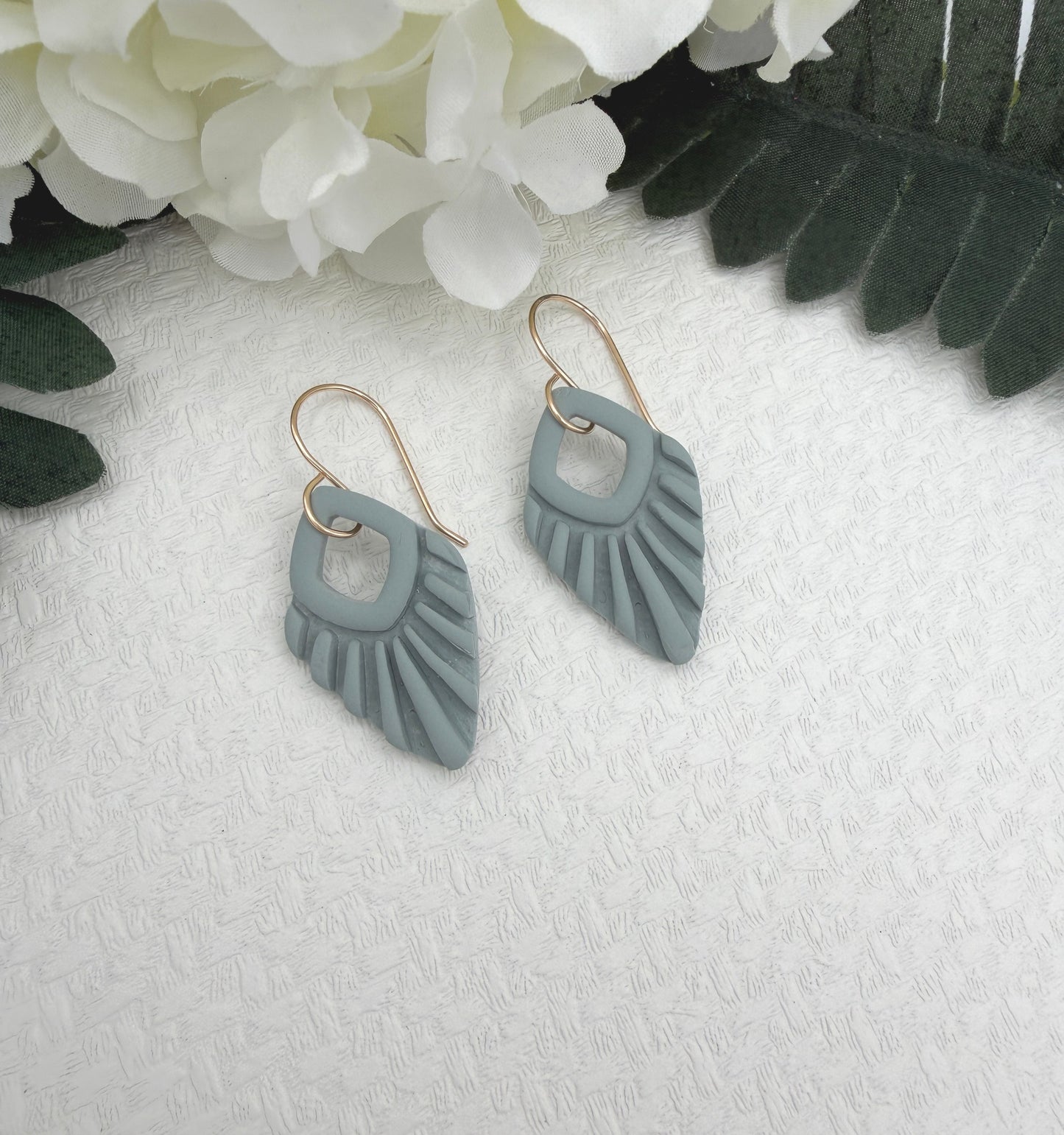 Earrings Made with Blue Polymer Clay Shaped into Lined, Teardrop Frames PCE-1041