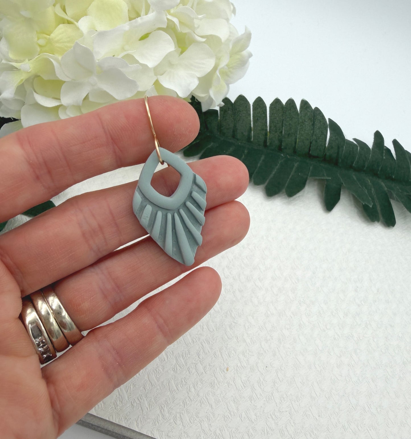 Earrings Made with Blue Polymer Clay Shaped into Lined, Teardrop Frames PCE-1041