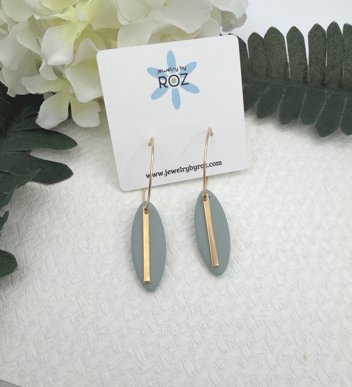 Earrings Made with Blue Polymer Clay Shaped into Ovals with Gold Plated LInes on Hoops PCE-1043