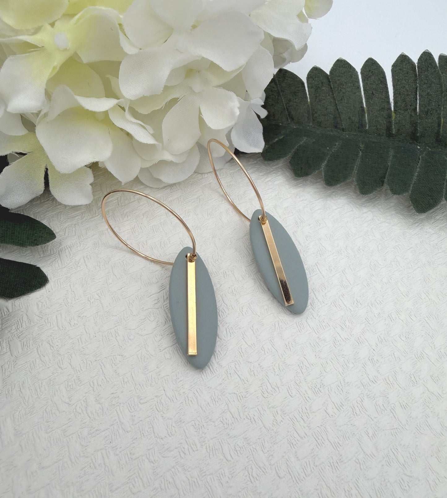 Earrings Made with Blue Polymer Clay Shaped into Ovals with Gold Plated LInes on Hoops PCE-1043