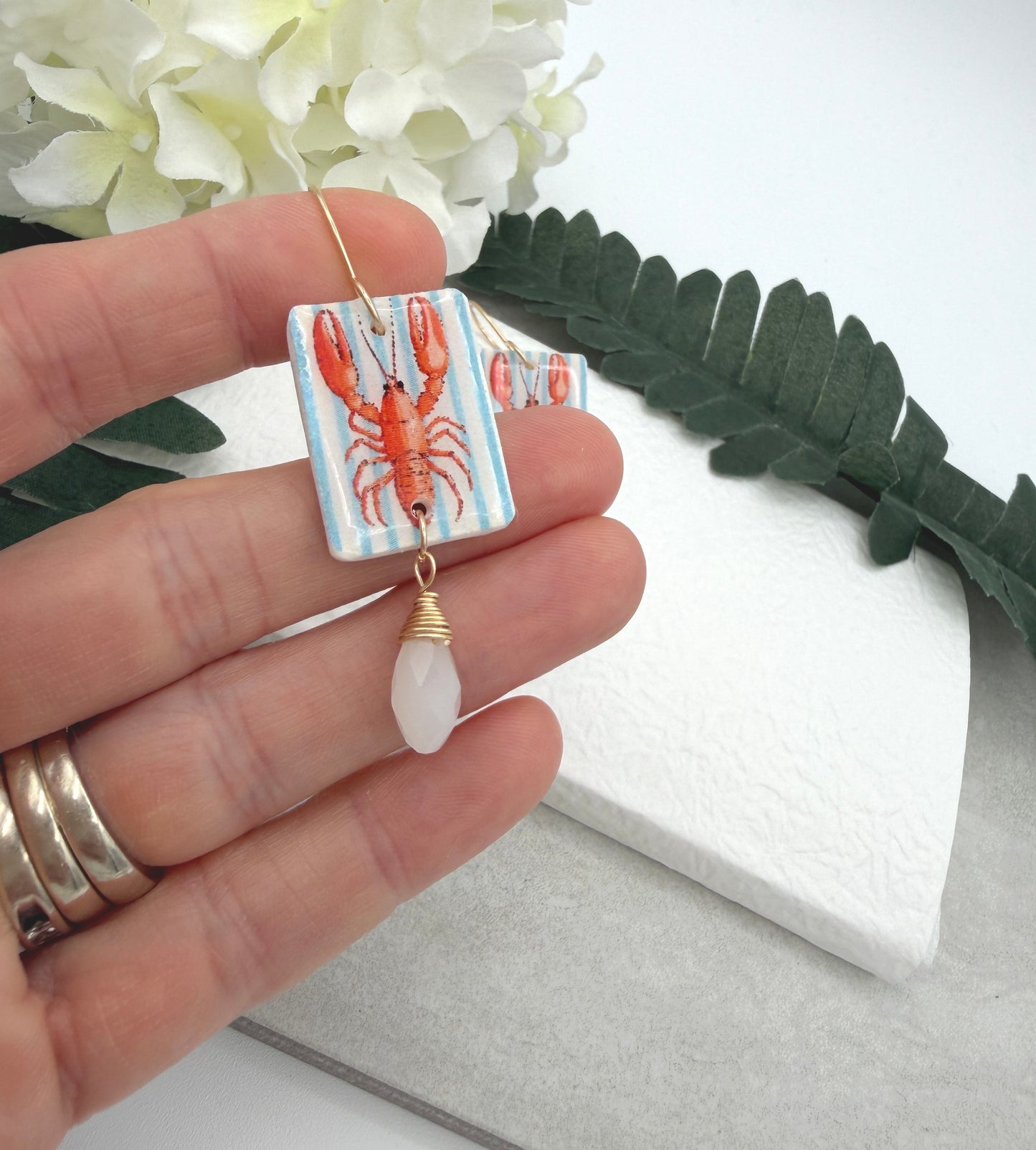 Earrings Made with White Polymer Clay with a Lobster Design and White Crystal Drop PCE-1056