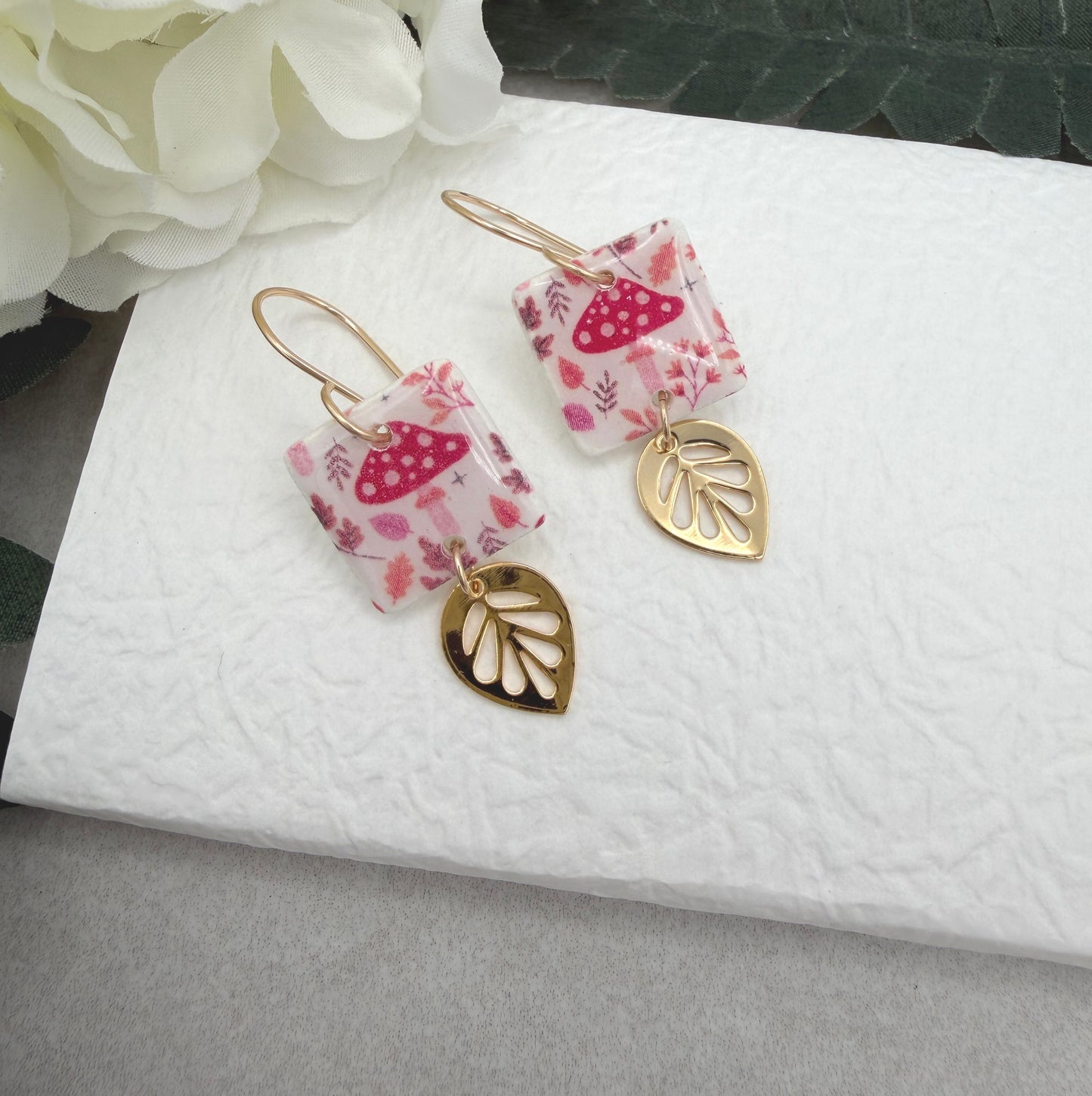 Earrings Made with White Polymer Clay with a Mushroom Pattern and Gold Plated Leaf Charms PCE-1064