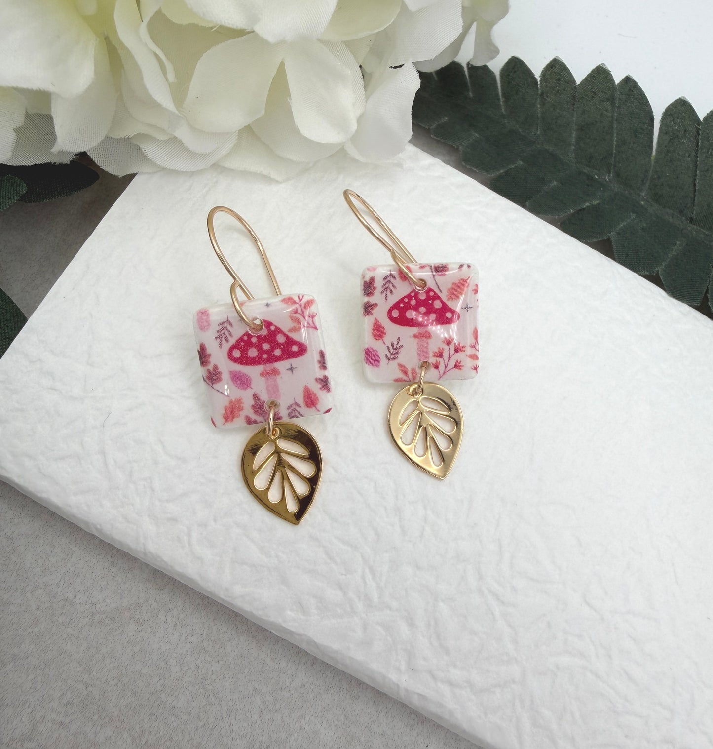 Earrings Made with White Polymer Clay with a Mushroom Pattern and Gold Plated Leaf Charms PCE-1064