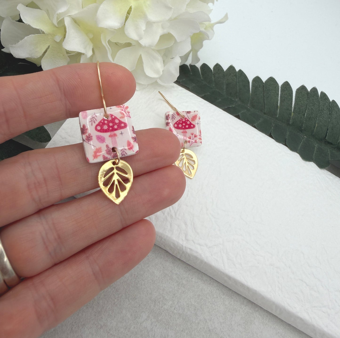 Earrings Made with White Polymer Clay with a Mushroom Pattern and Gold Plated Leaf Charms PCE-1064