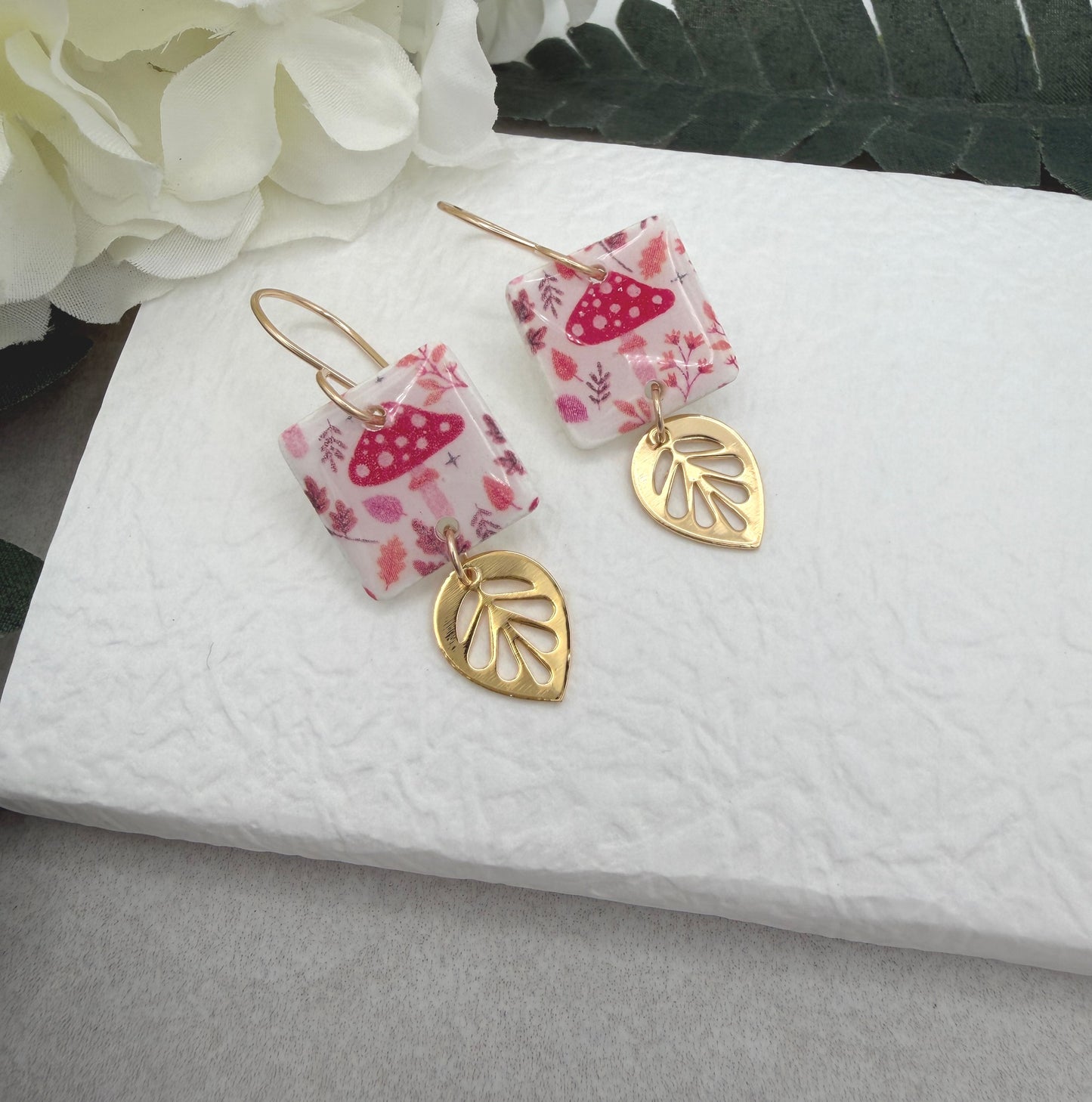 Earrings Made with White Polymer Clay with a Mushroom Pattern and Gold Plated Leaf Charms PCE-1064