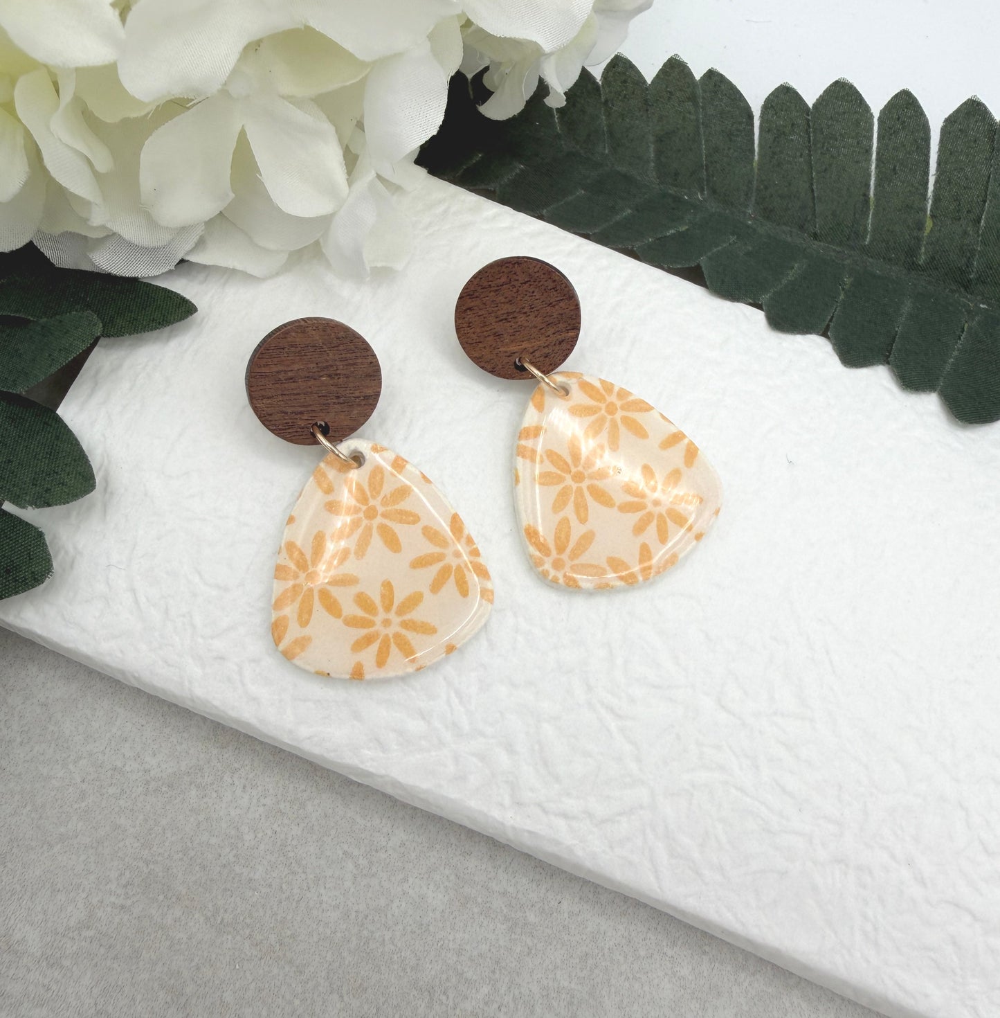 Earrings Made with White Polymer Clay Teardrops with a Yellow Flower Pattern and Wood Posts PCE-1067