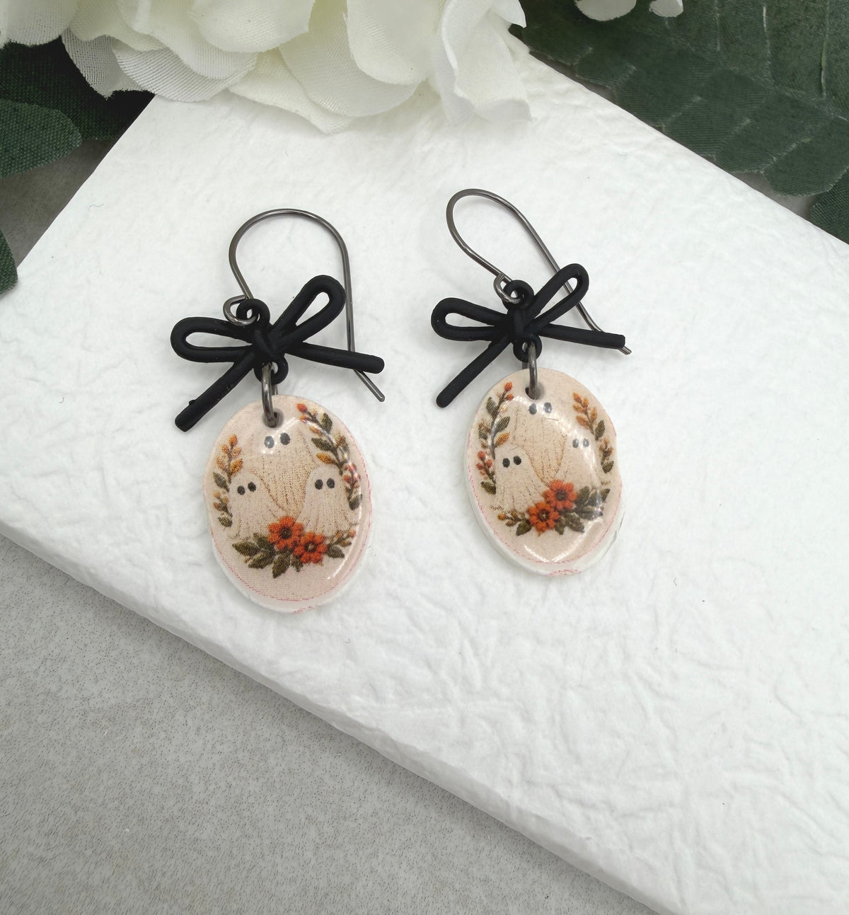 Earrings Made with Black Bow LInks and Polymer Clay Ovals with a Ghost Design and Oxidized Silver Earring Wires PCE-1084