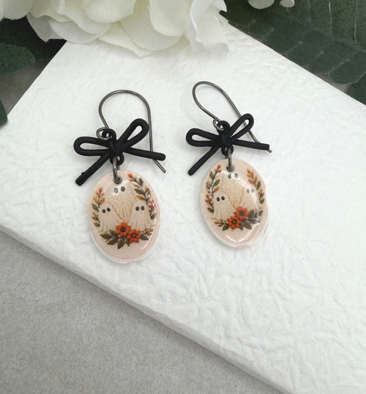Earrings Made with Black Bow LInks and Polymer Clay Ovals with a Ghost Design and Oxidized Silver Earring Wires PCE-1084