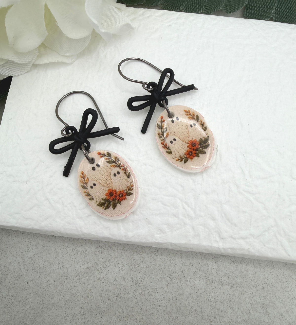 Earrings Made with Black Bow LInks and Polymer Clay Ovals with a Ghost Design and Oxidized Silver Earring Wires PCE-1084