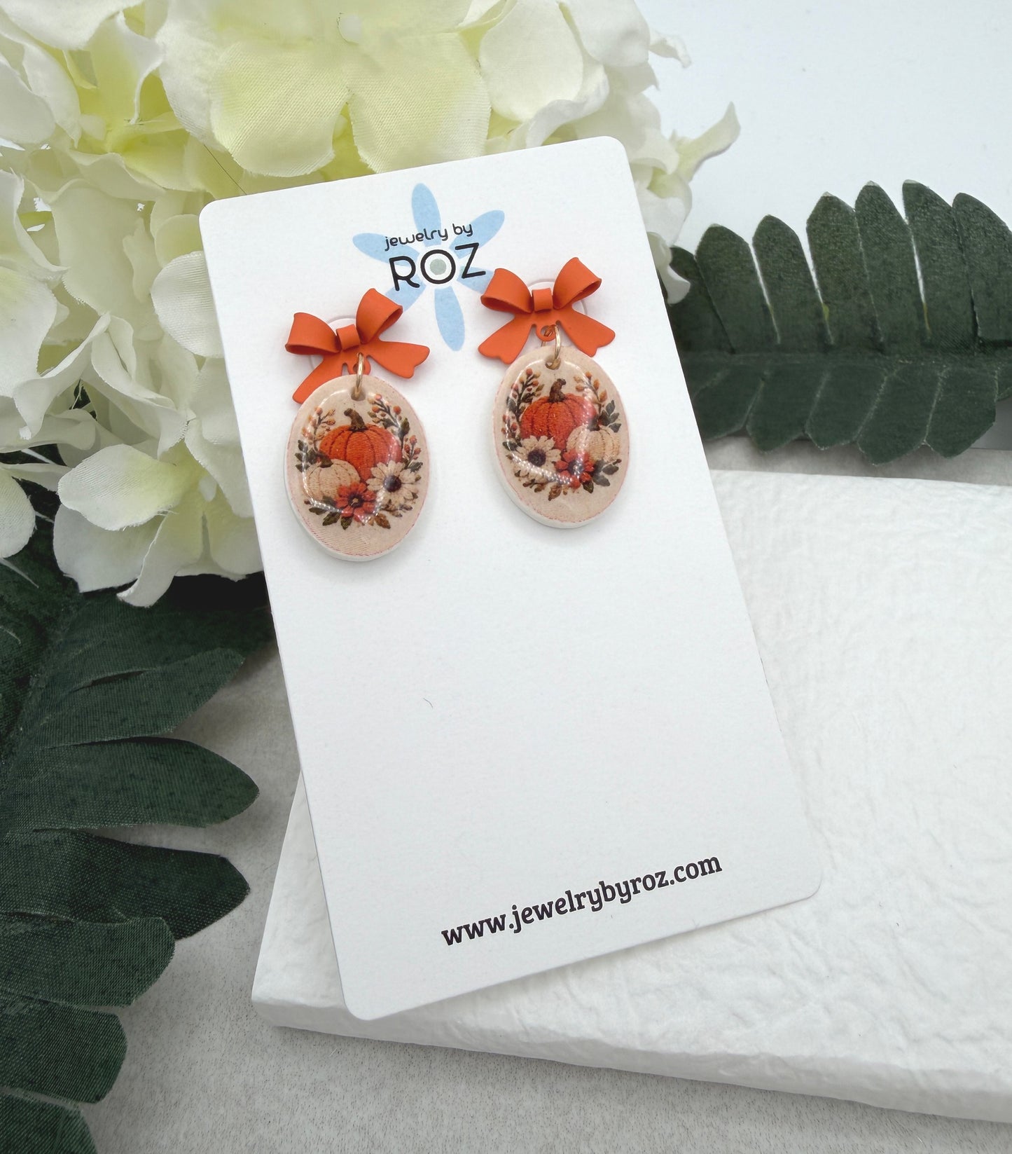 Earrings Made with Orange Bow Posts and Polymer Clay Ovals with a Pumpkin Design PCE-1089