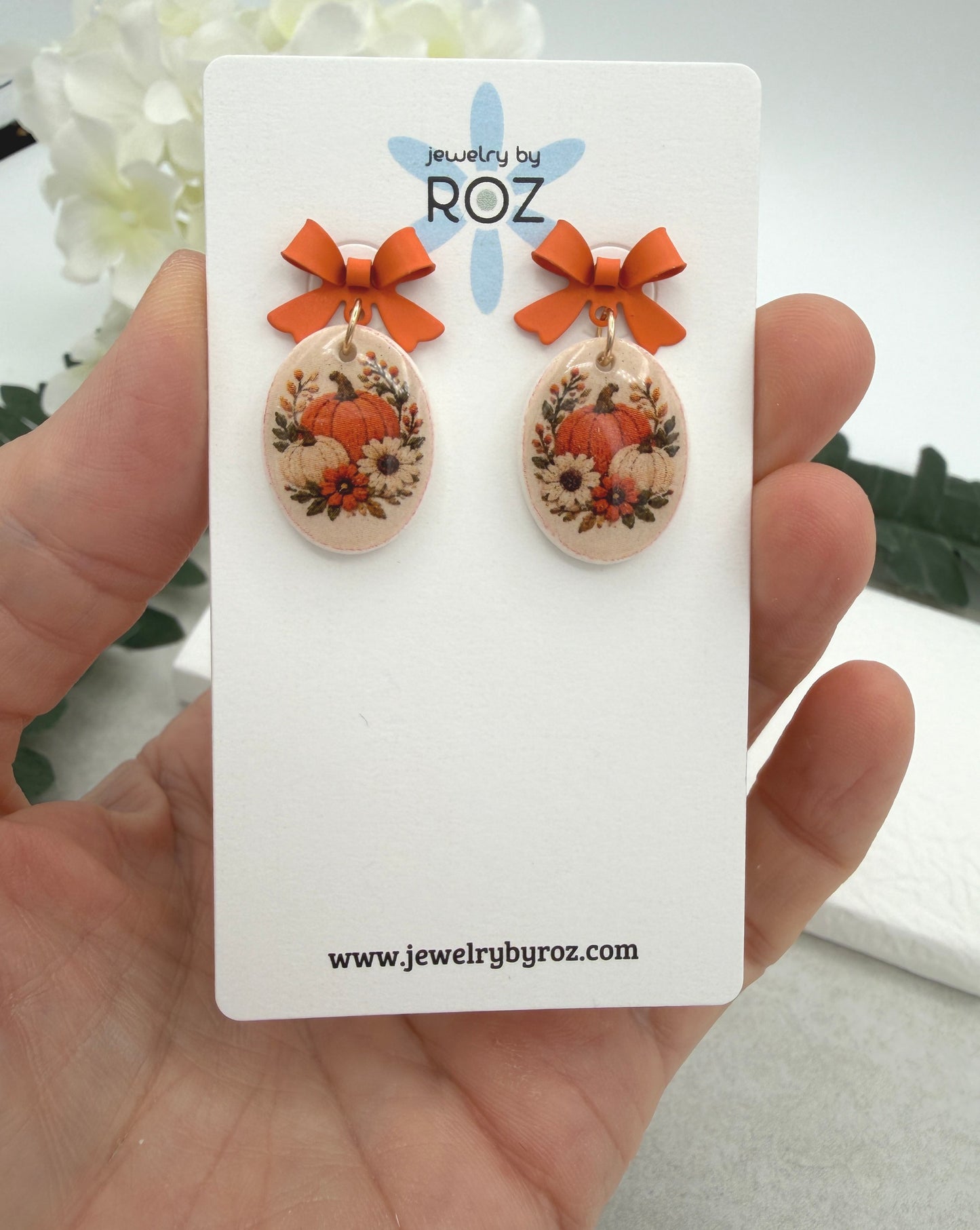 Earrings Made with Orange Bow Posts and Polymer Clay Ovals with a Pumpkin Design PCE-1089
