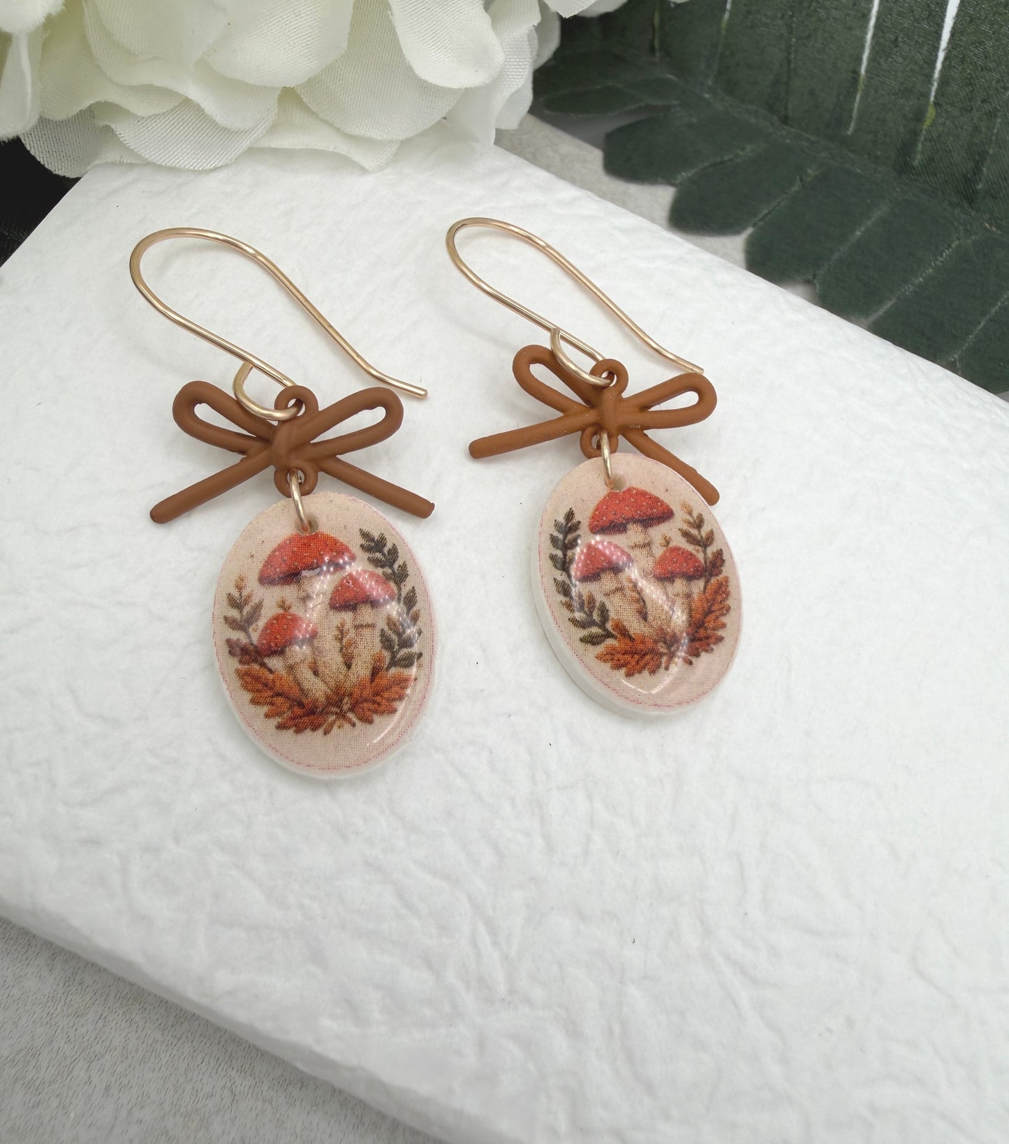 Earrings Made with Brown Bow LInks and Polymer Clay Ovals with a Mushroon Design and Gold Filled Earring Wires PCE-1092