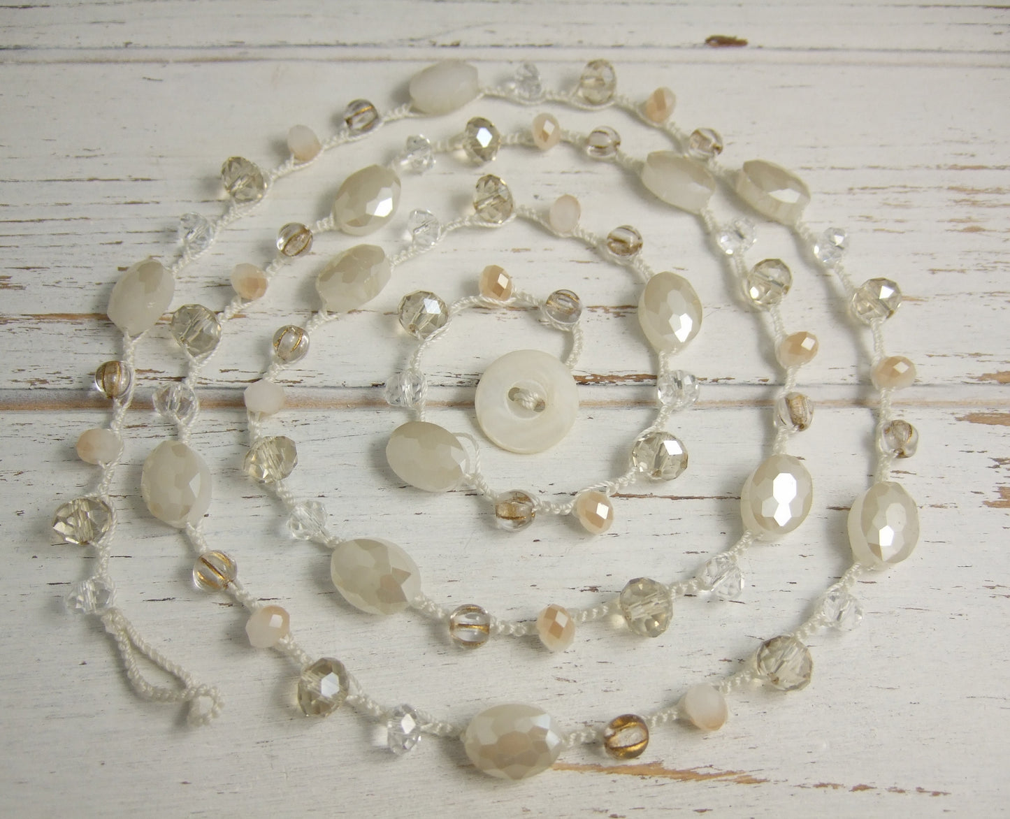 A Long Crocheted Necklace with a Cream Cord, Cream, Gold and Crystal Czech Glass Beads SN-524