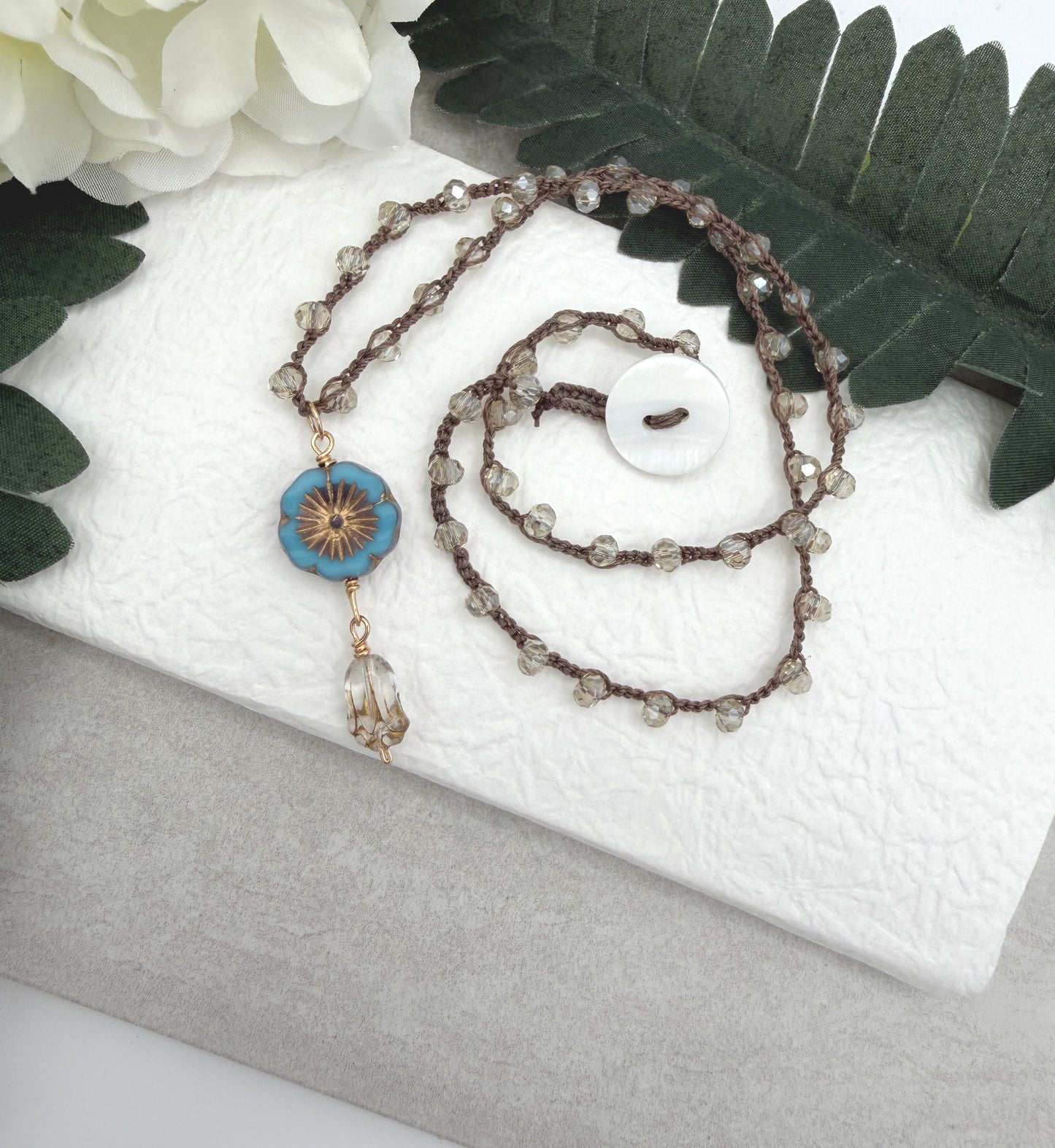 Crocheted Necklace with a Brown Cord, Crystal Beads, a Czech Glass Blue Flower, and Gold Glass Tulip Bead SN-675