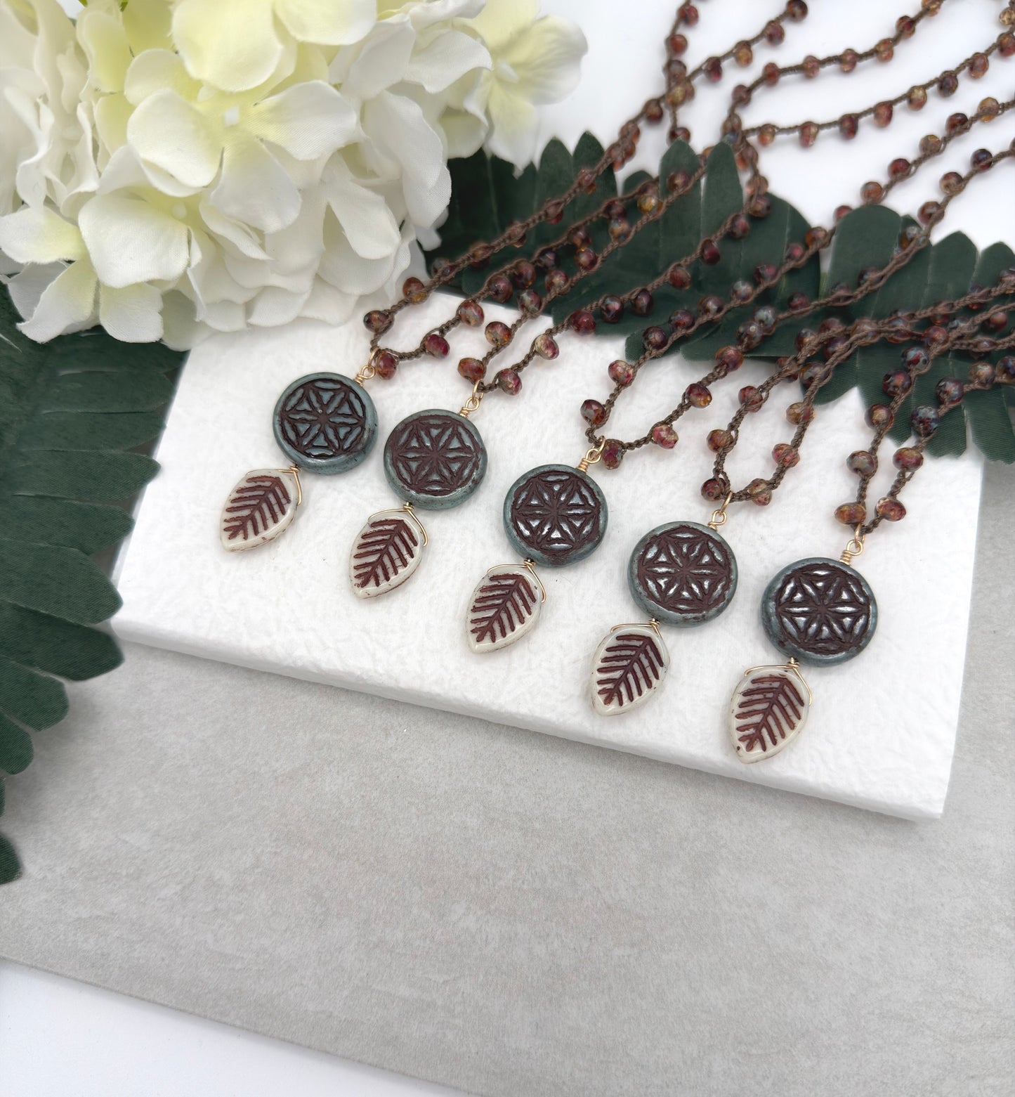 Crocheted Necklace with a Brown Cord, Red Brown Rondelles, Blue Green Flower of Life Bead and Cream Brown Leaf Bead SN-680