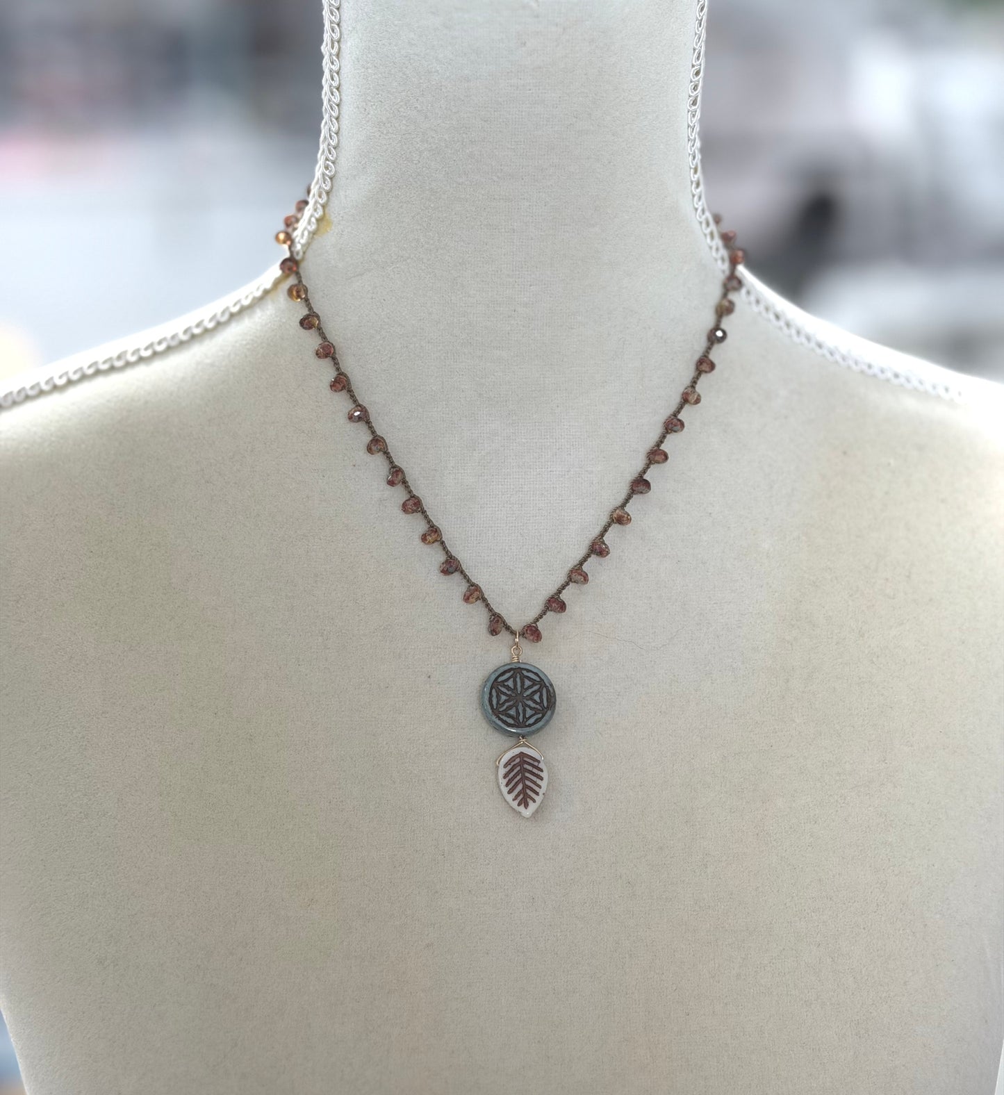 Crocheted Necklace with a Brown Cord, Red Brown Rondelles, Blue Green Flower of Life Bead and Cream Brown Leaf Bead SN-680