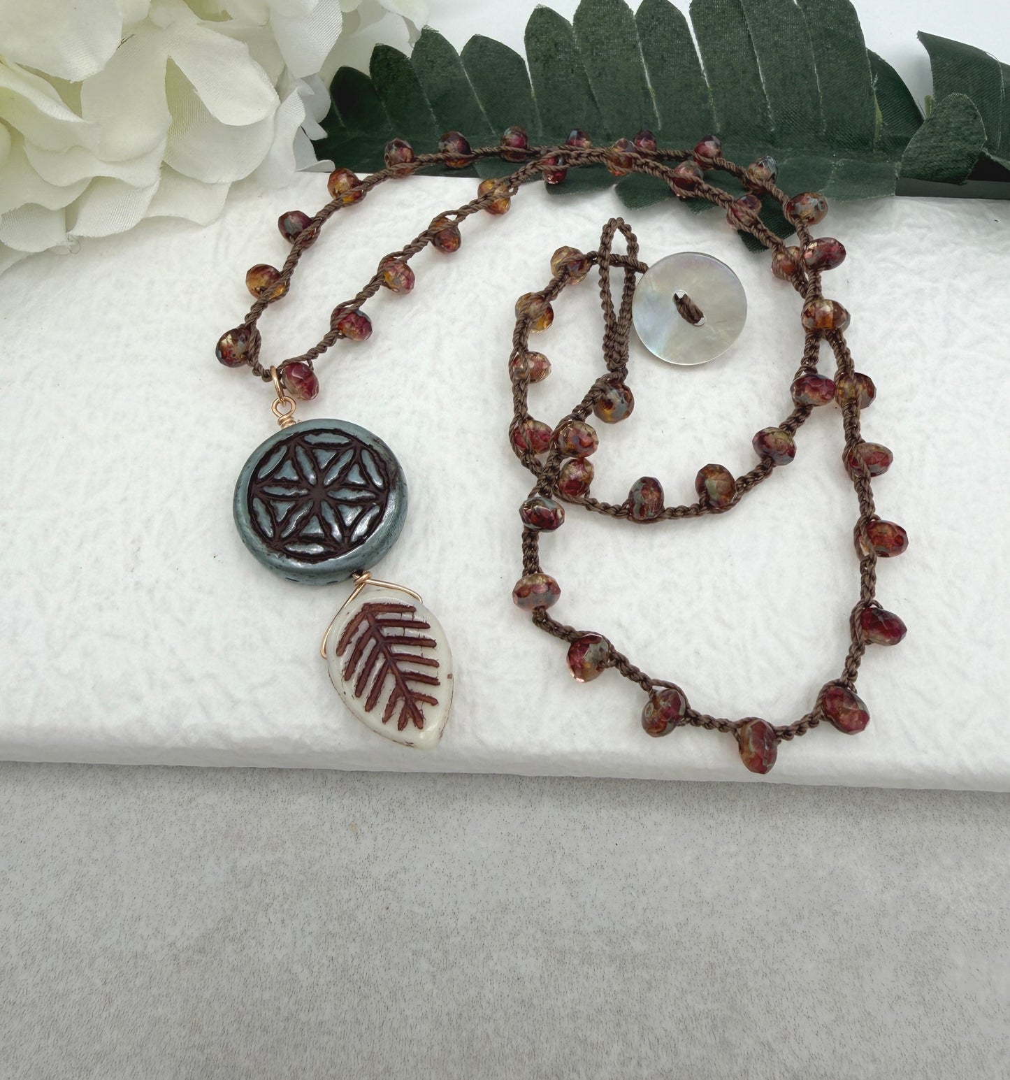 Crocheted Necklace with a Brown Cord, Red Brown Rondelles, Blue Green Flower of Life Bead and Cream Brown Leaf Bead SN-680