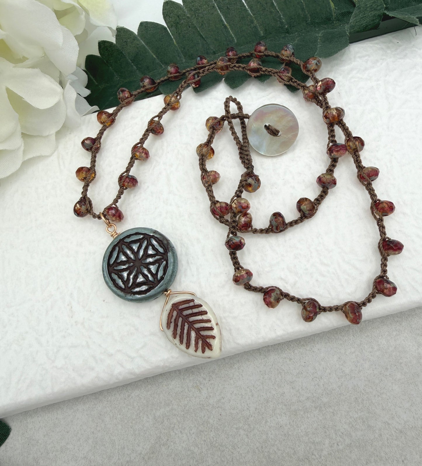 Crocheted Necklace with a Brown Cord, Red Brown Rondelles, Blue Green Flower of Life Bead and Cream Brown Leaf Bead SN-680