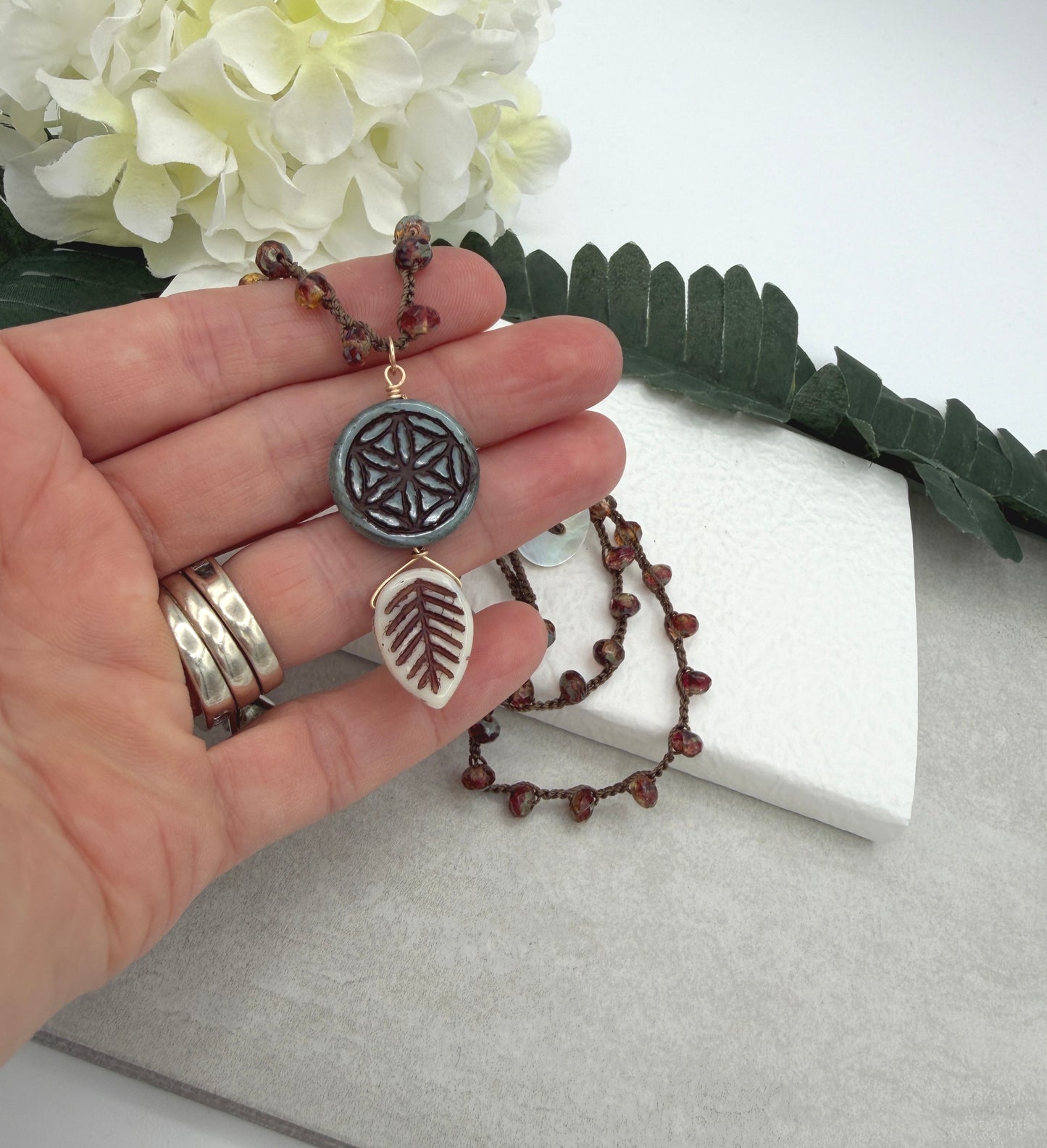 Crocheted Necklace with a Brown Cord, Red Brown Rondelles, Blue Green Flower of Life Bead and Cream Brown Leaf Bead SN-680