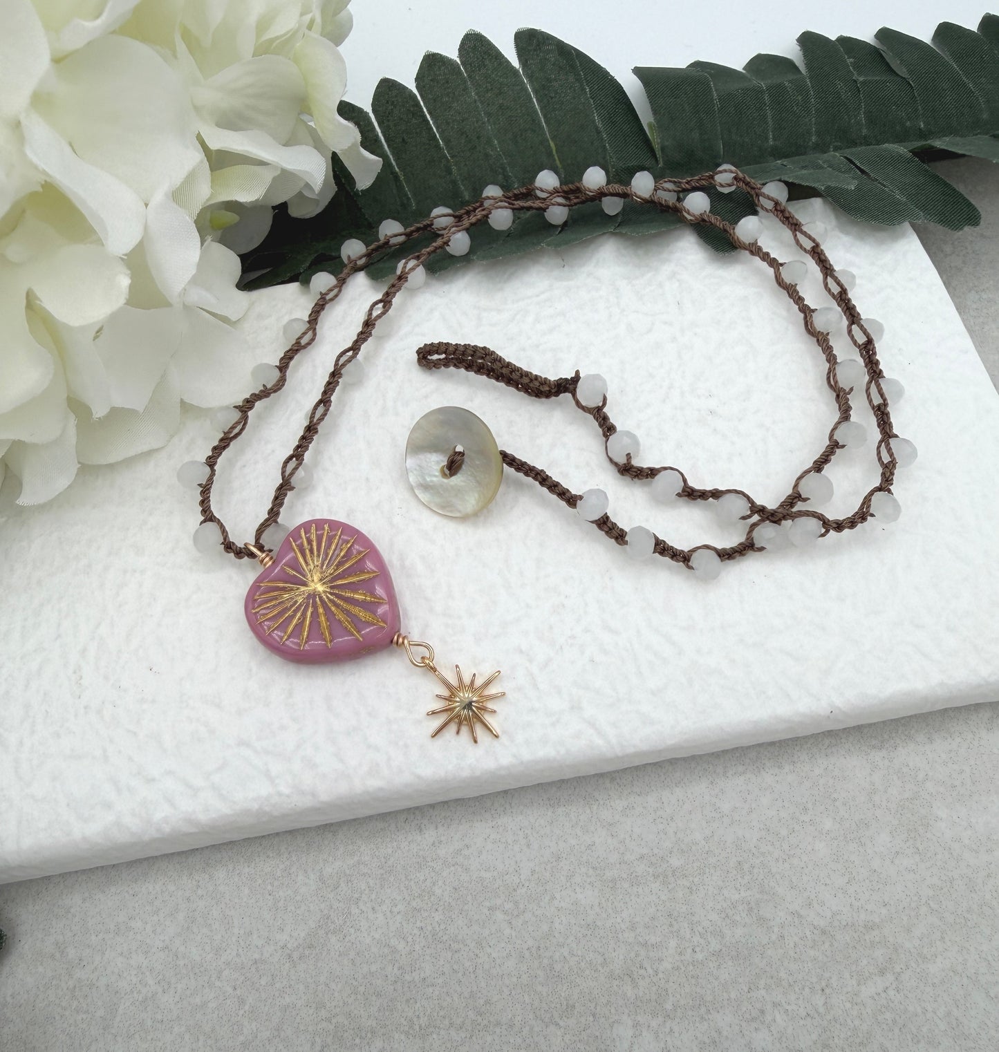 Crocheted Necklace with a Brown Cord, White Crystal Beads, a Pink Starburst Heart and Gold Star SN-681