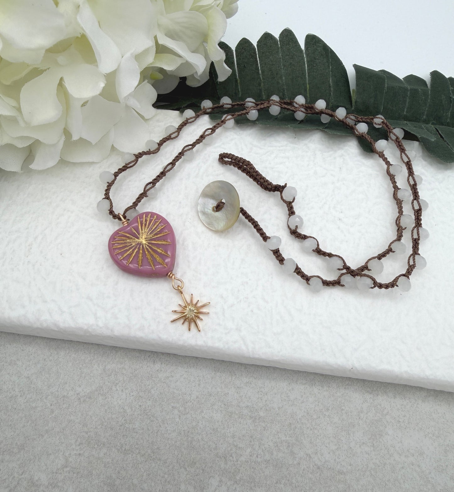 Crocheted Necklace with a Brown Cord, White Crystal Beads, a Pink Starburst Heart and Gold Star SN-681