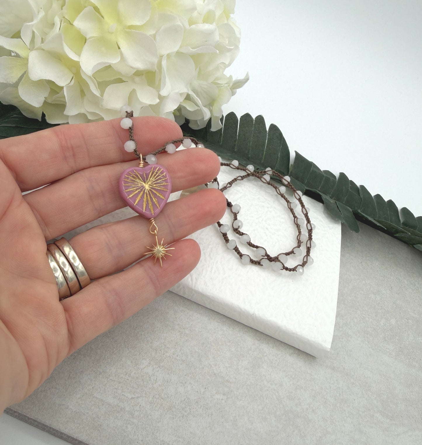Crocheted Necklace with a Brown Cord, White Crystal Beads, a Pink Starburst Heart and Gold Star SN-681