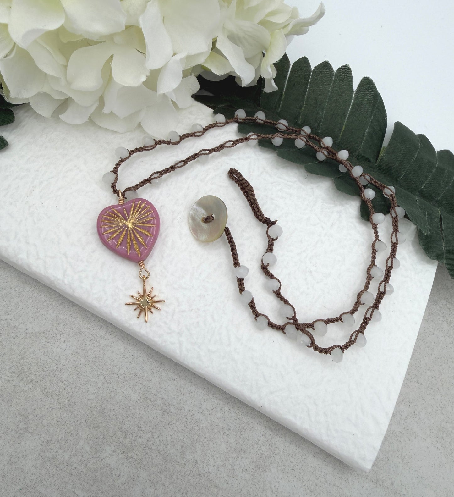Crocheted Necklace with a Brown Cord, White Crystal Beads, a Pink Starburst Heart and Gold Star SN-681