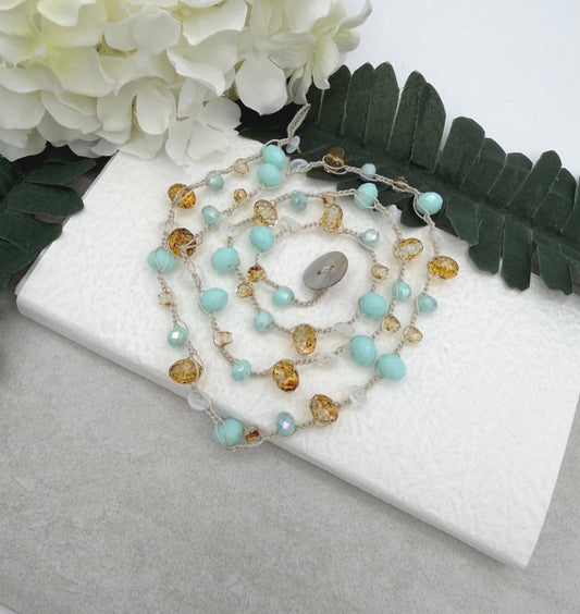 A Long Crocheted Necklace with an Ivory Cord With Aqua, Gold and Mily White Czech Glass Ronds SN-685