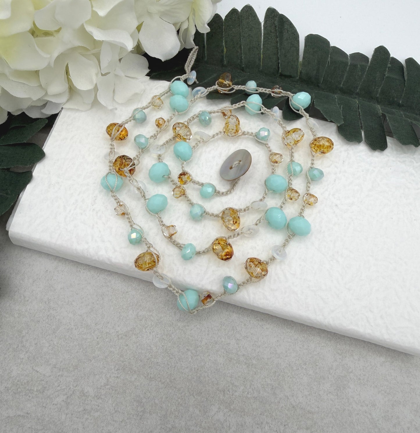 A Long Crocheted Necklace with an Ivory Cord With Aqua, Gold and Mily White Czech Glass Ronds SN-685